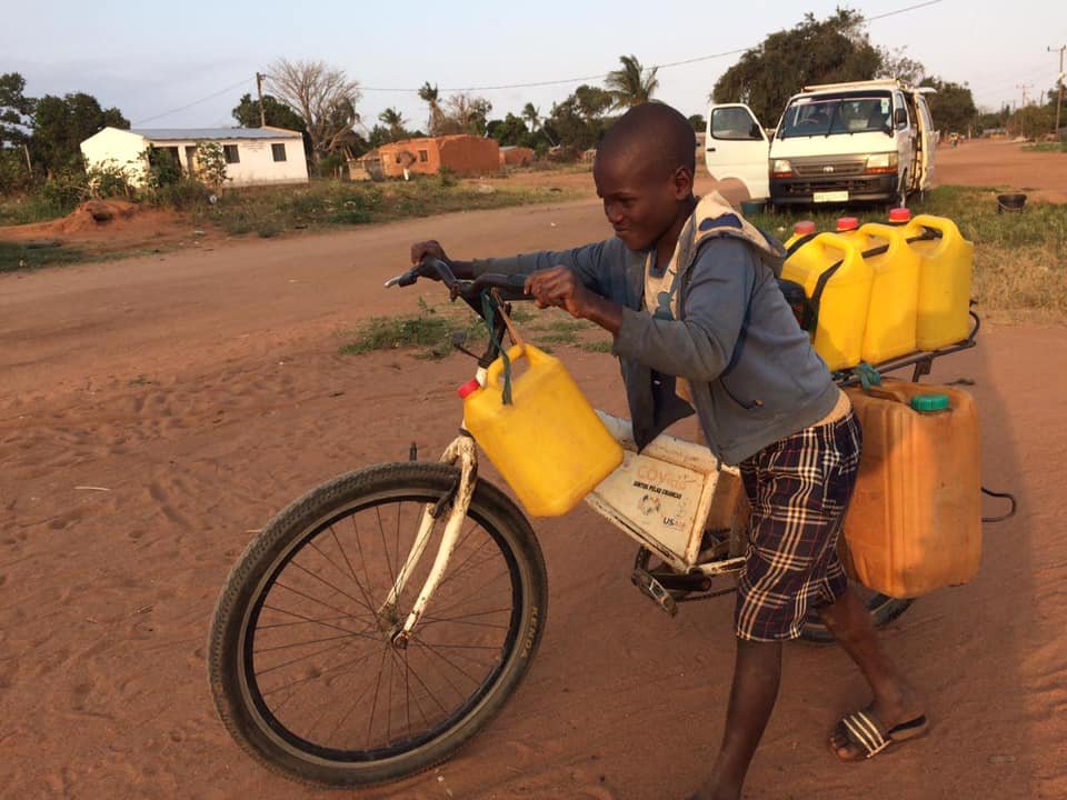 Transport - Bike- boy carrying water.jpg