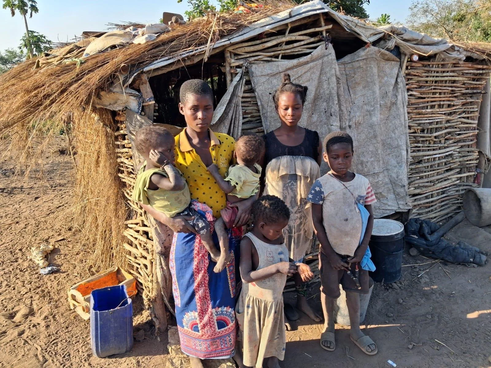 Bandua Aug 2026 - family before house.jpg