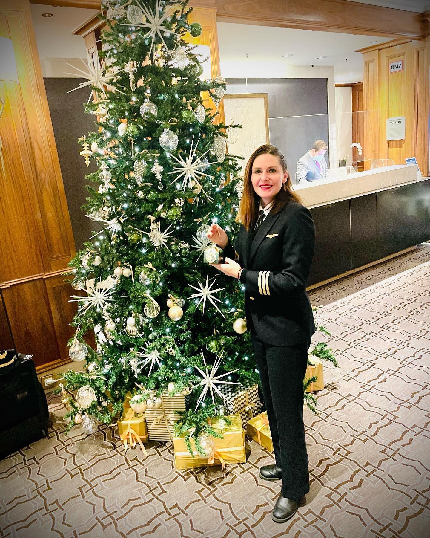 The hotel lobby in Berlin, Germany is Merry &amp; Bright!
All of our hotel room door handles were draped with chocolate boxes when we woke up! (I&rsquo;m holding the chocolate box). ✈️ 👩&zwj;✈️

#travel #adventure#aviation #aviatrix #pilotlife #chri