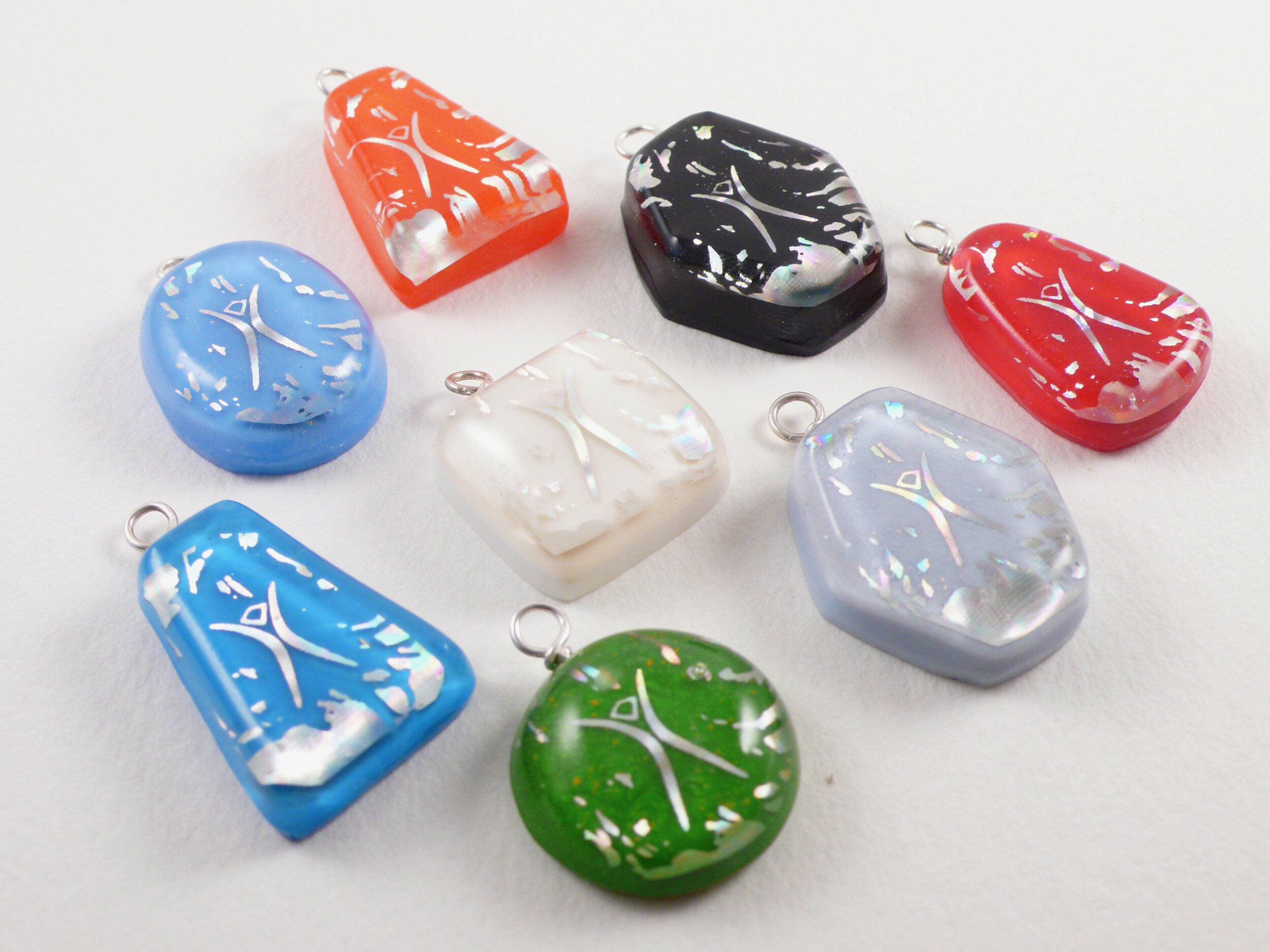 pendants: cast resin with holographic foil waste from the 2009 Burning Man ticket