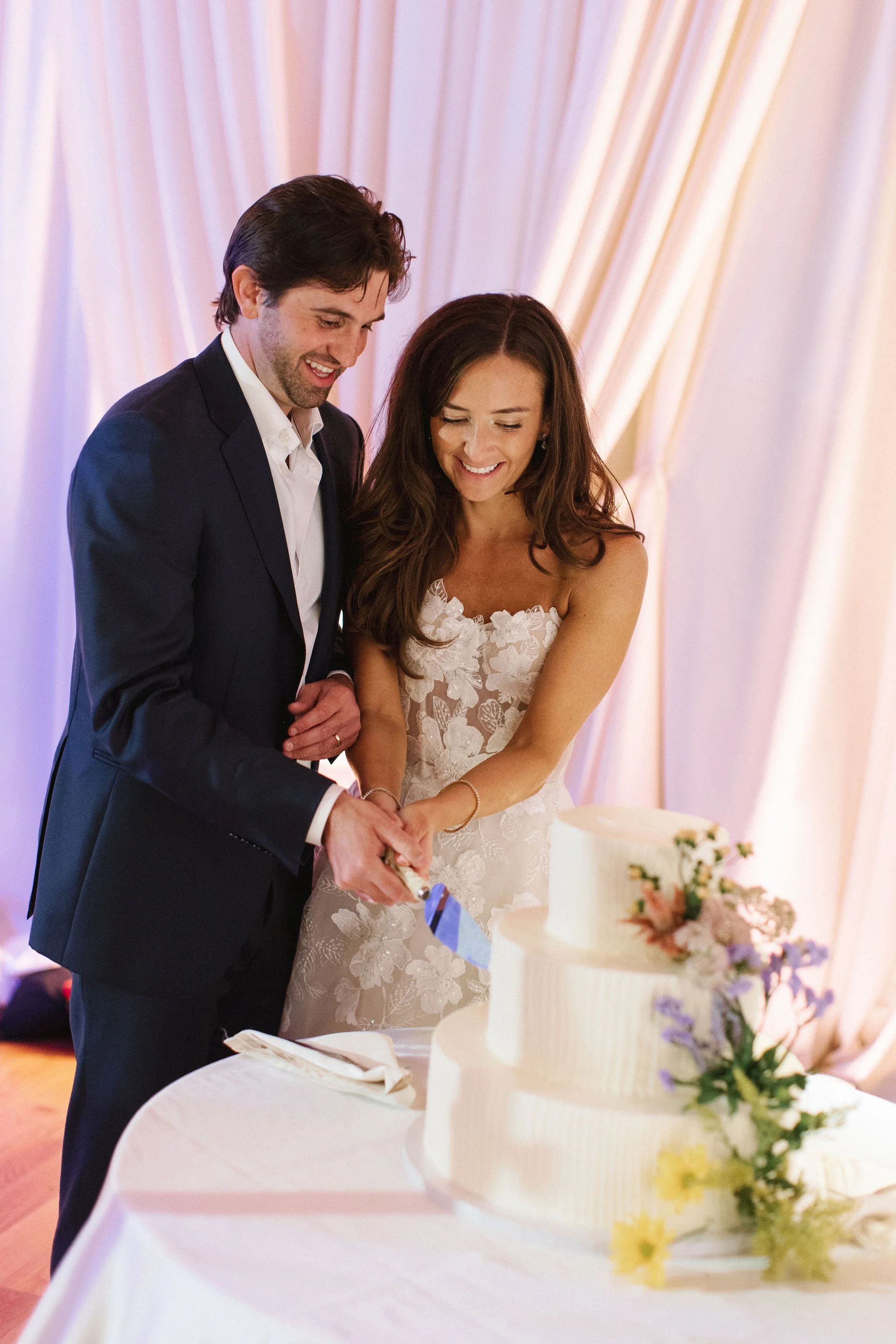 bride and groom cutting cake