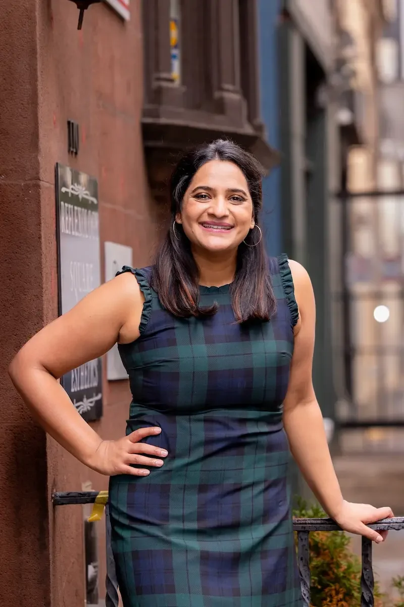 aparna standing on philadelphia street smiling