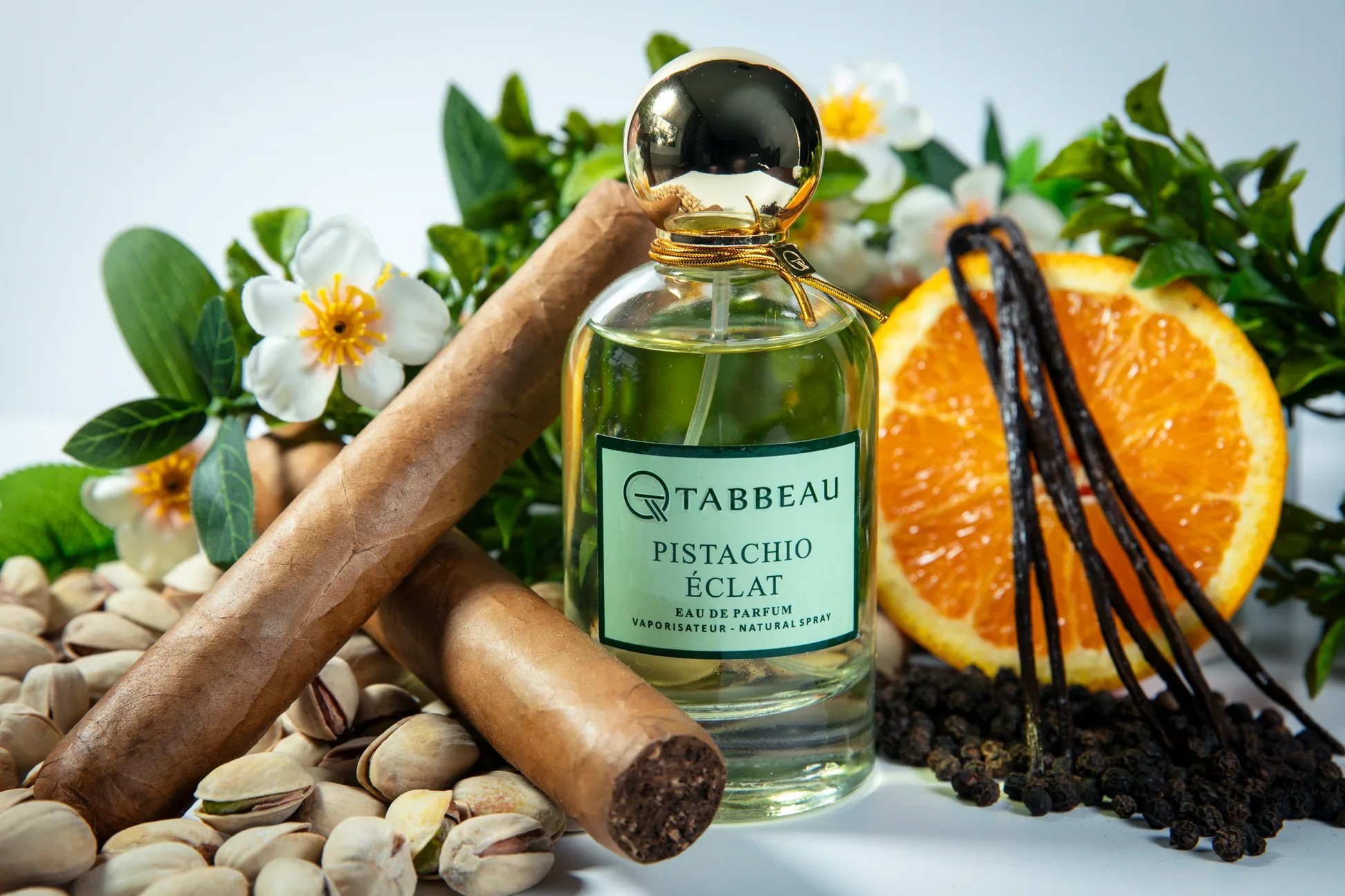 A flat lay of pistachio perfume bottles on a soft neutral background with pistachio nuts scattered around — 2026 fragrance trend guide by Fragrantix