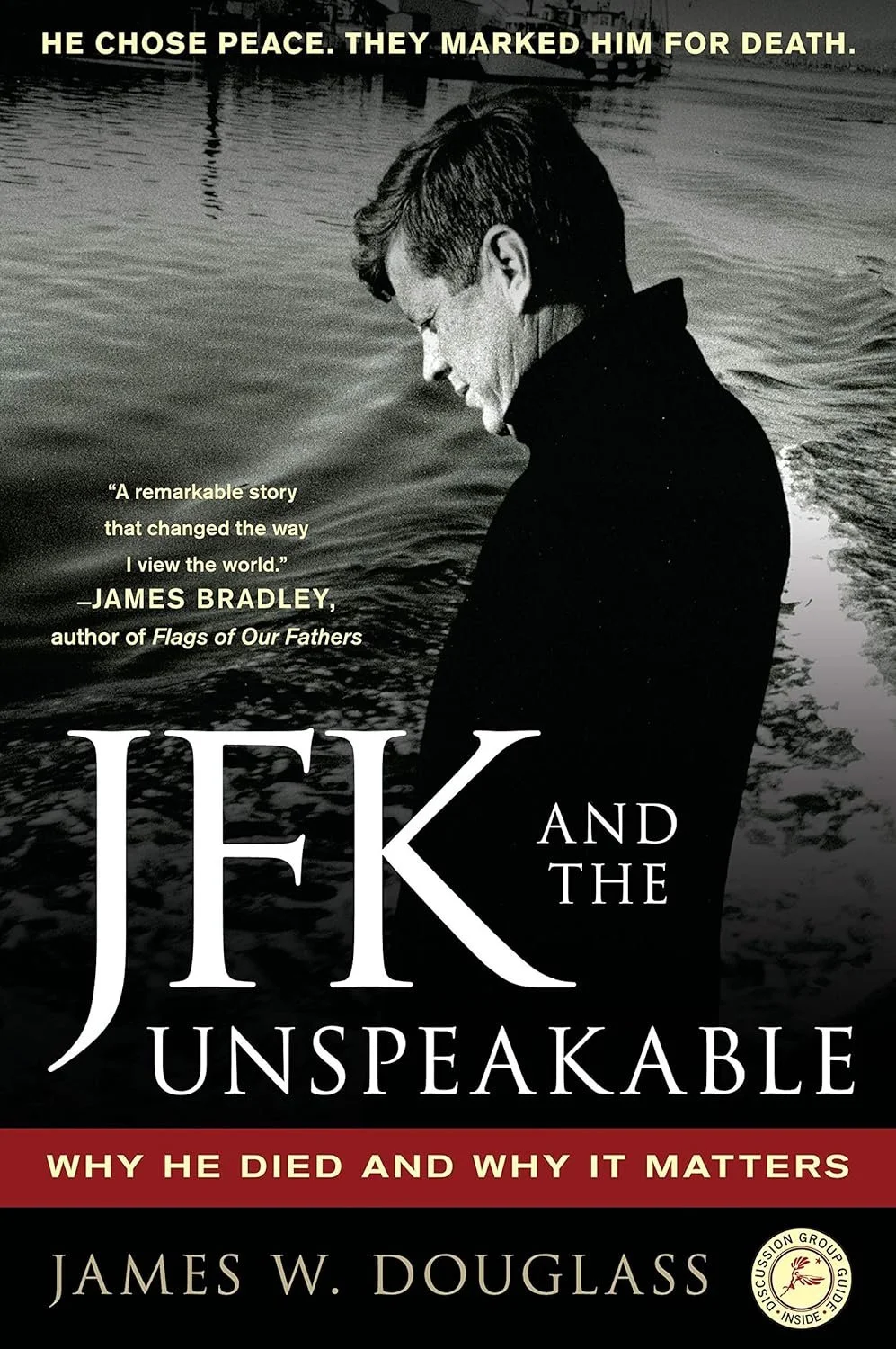 Book cover of 'JFK and the Unspeakable' by James W. Douglass, featuring a black and white photo of John F. Kennedy looking down at water.