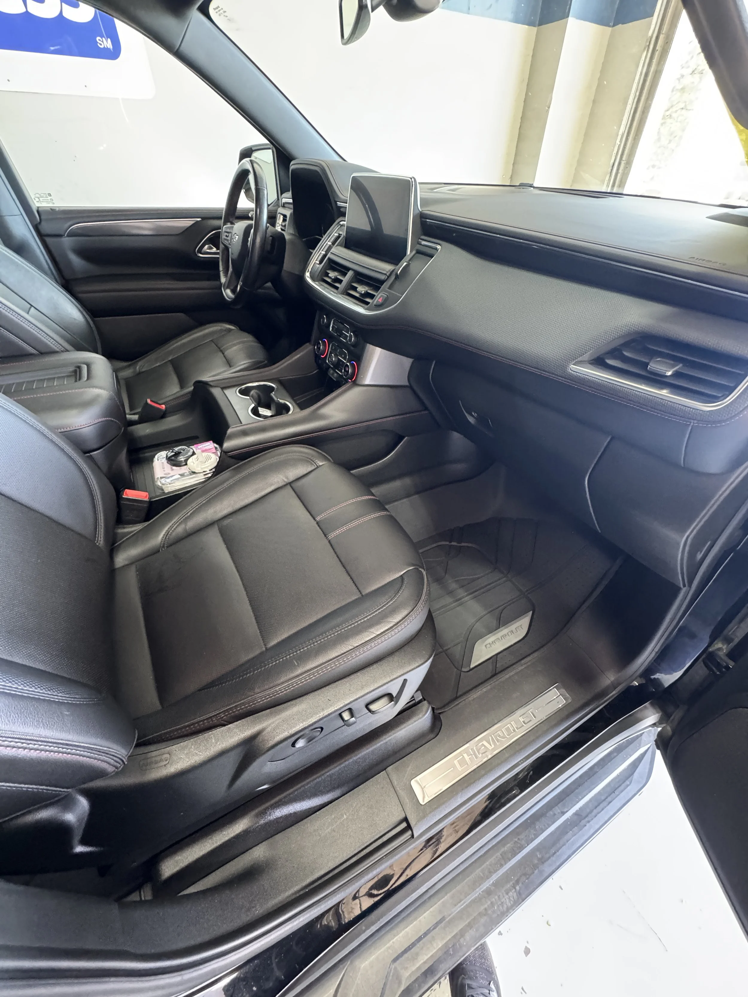 Interior of a Chevrolet vehicle, showing the front seats, dashboard, and center console with gear shifter and control buttons.
