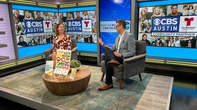 Two adults talking to each other at the CBS Austin News studio