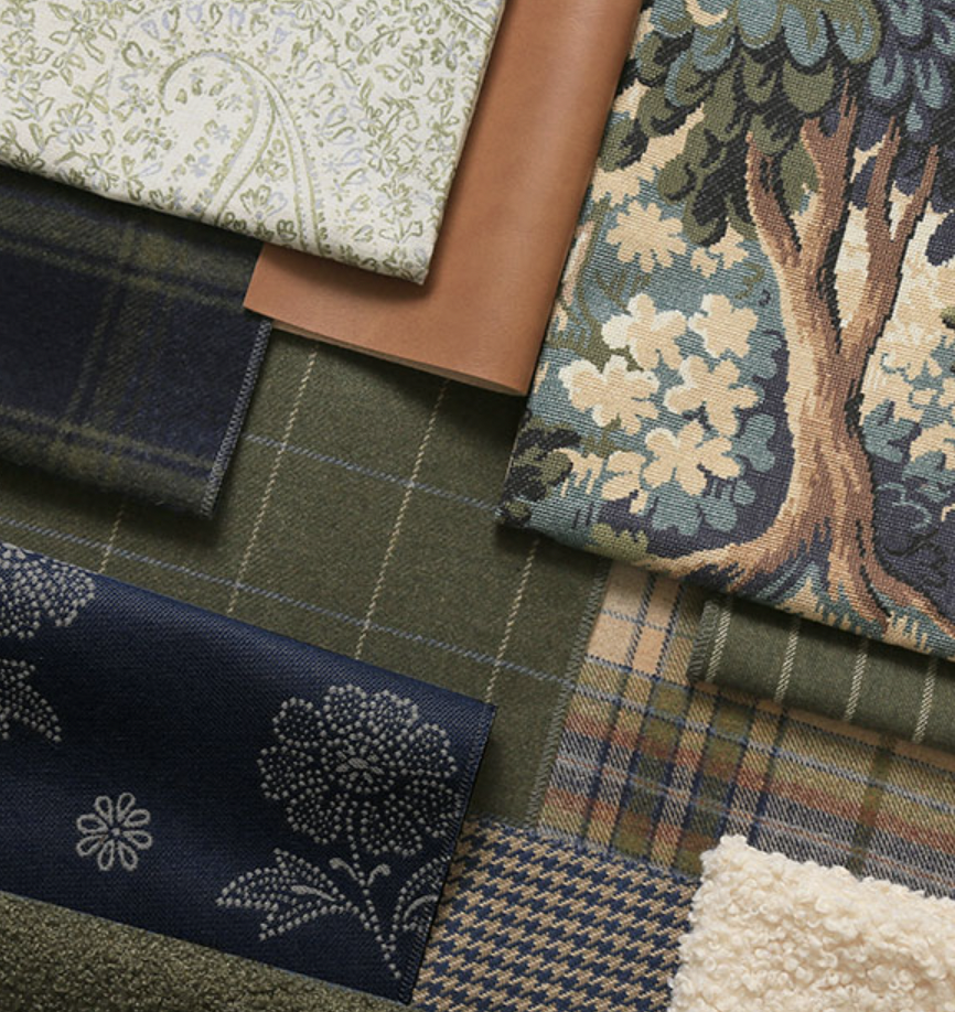 Stacked fabric samples with various patterns and textures, including a tree design, plaid, floral prints, and plain fabrics.