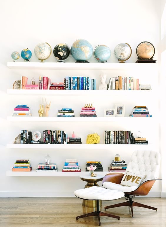 gatheraus - styling-a-bookshelf- colorful books globes.jpeg