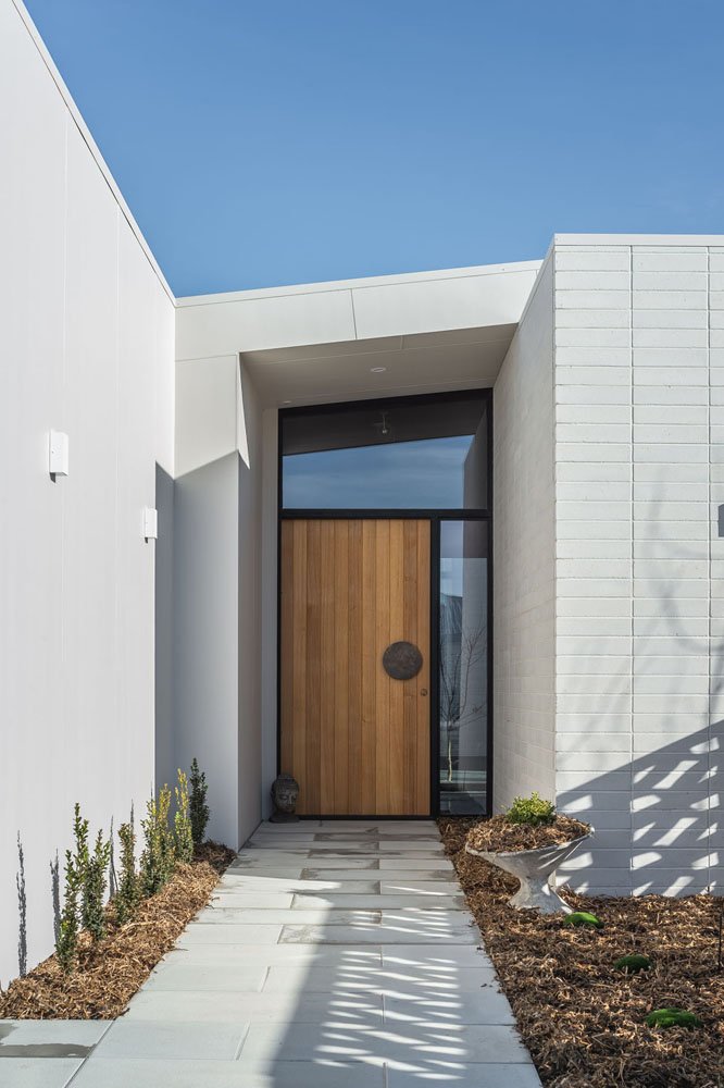 gatheraus-white-house-black-trim-wood-door.jpeg