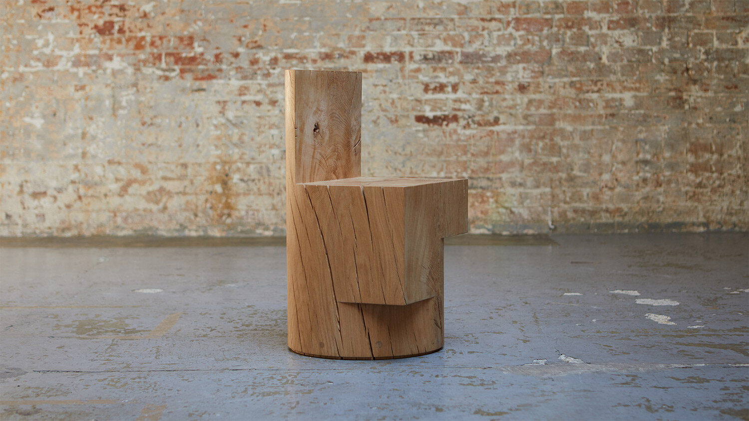 Carved wood chair against brick wall.jpg