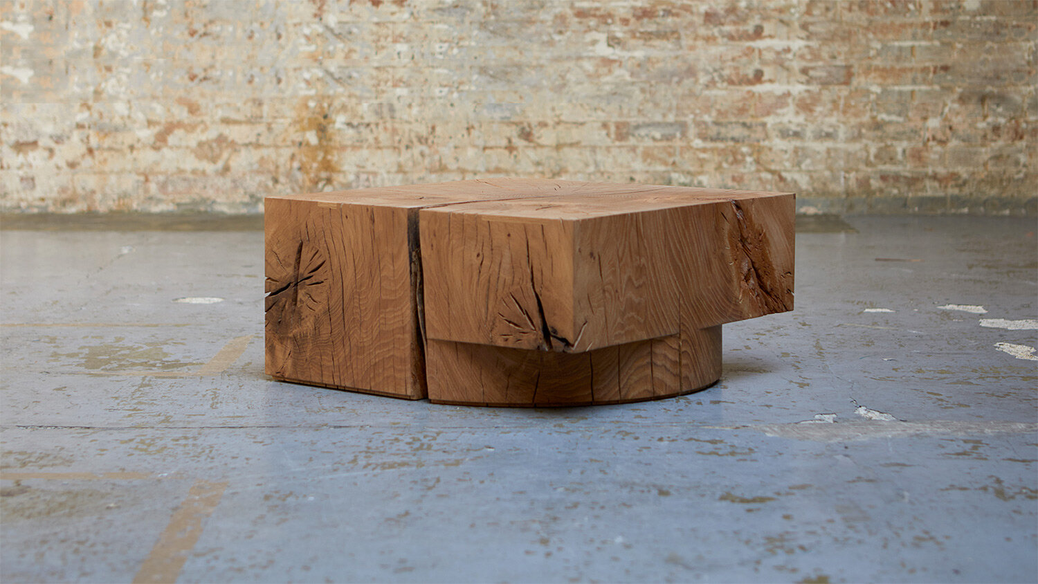 Carved wood coffee table against brick wall.jpg