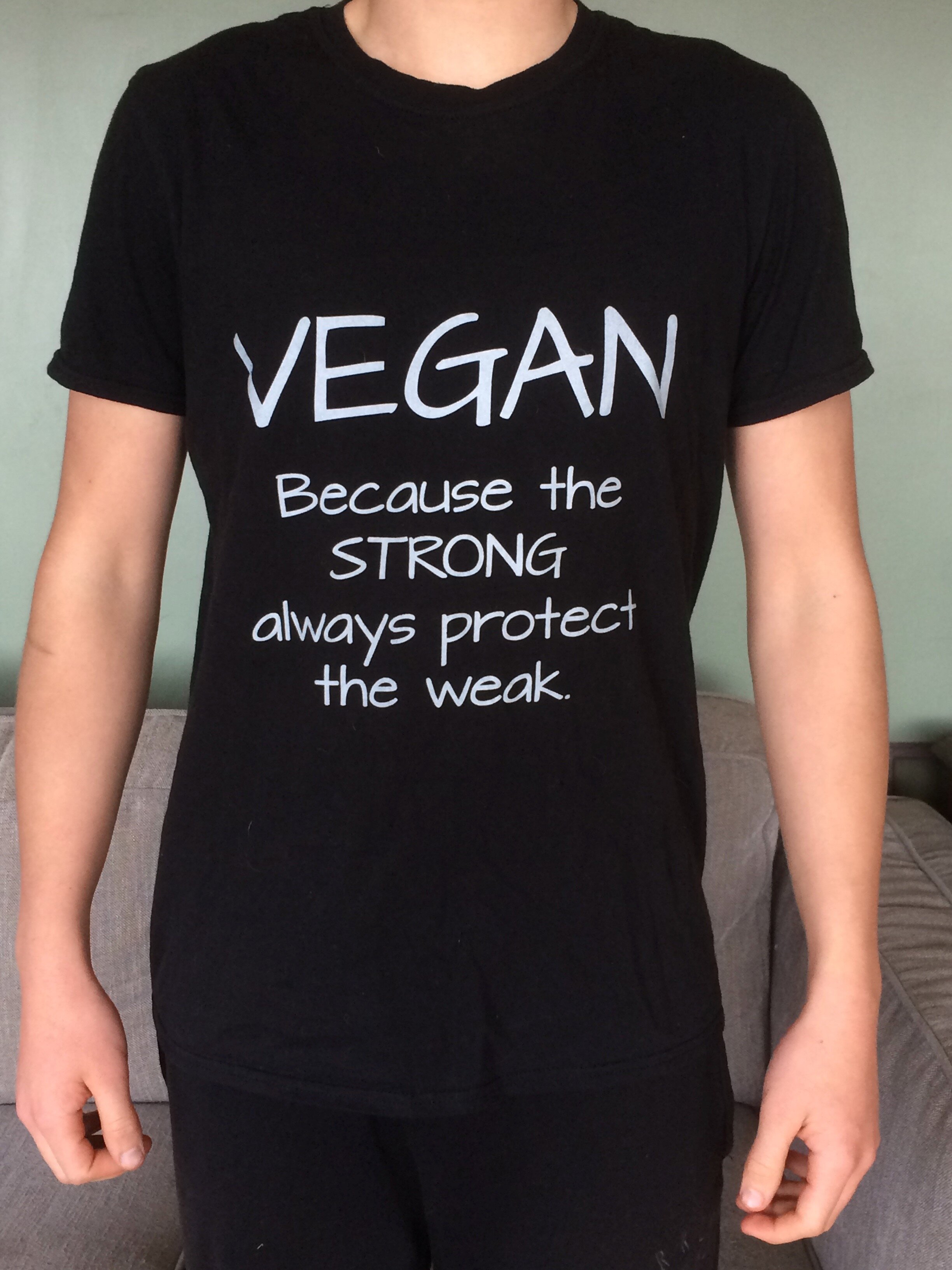 T-shirt with text 'Vegan, because the strong protect the weak'