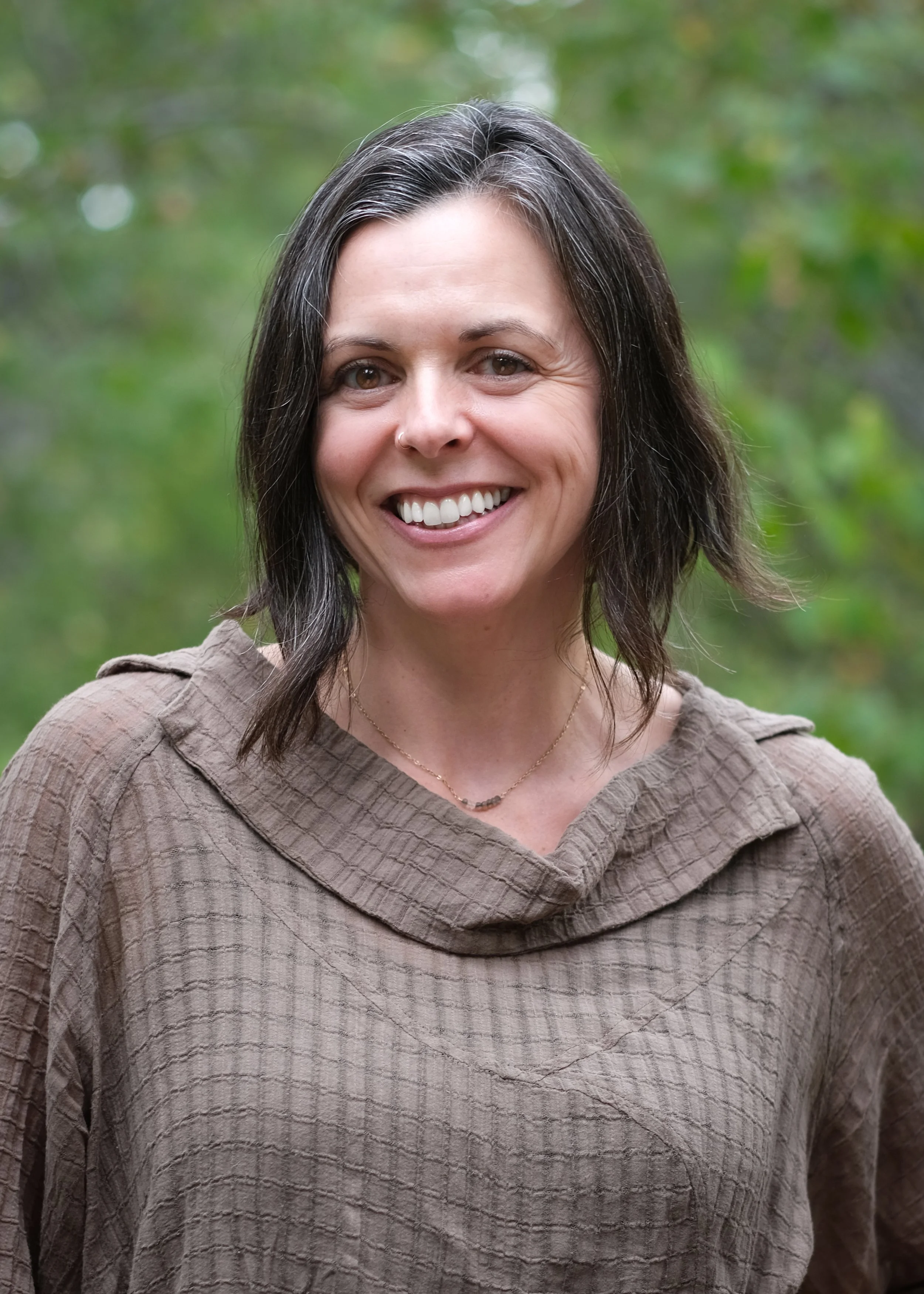 headshot of Mary smiling in nature