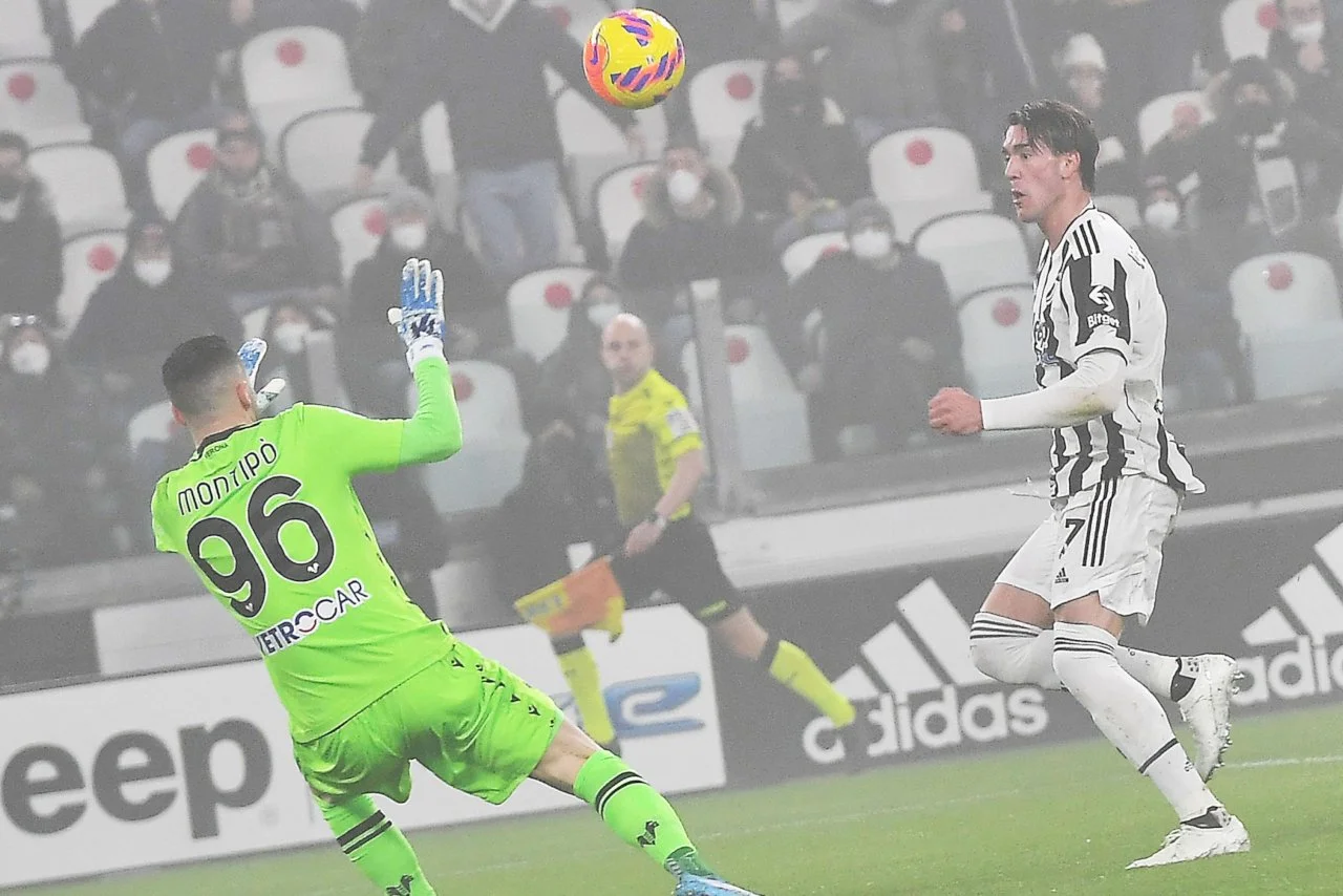 New Juventus signing Dusan Vlahovic scores a lob over Verona goalkeeper Lorenzo Montipò