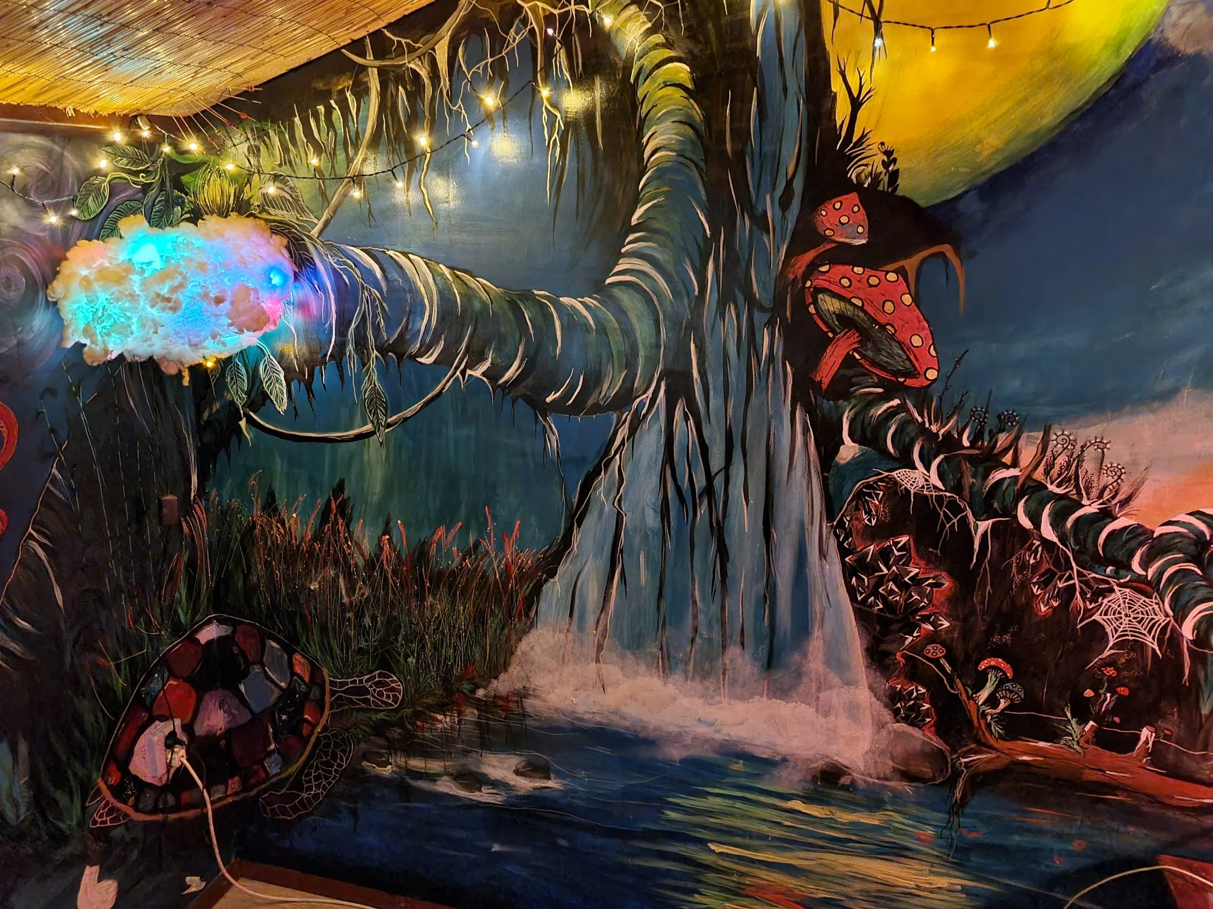 Colourful fantasy forest mural with a glowing tree, waterfall and winding roots, painted by Rolf.