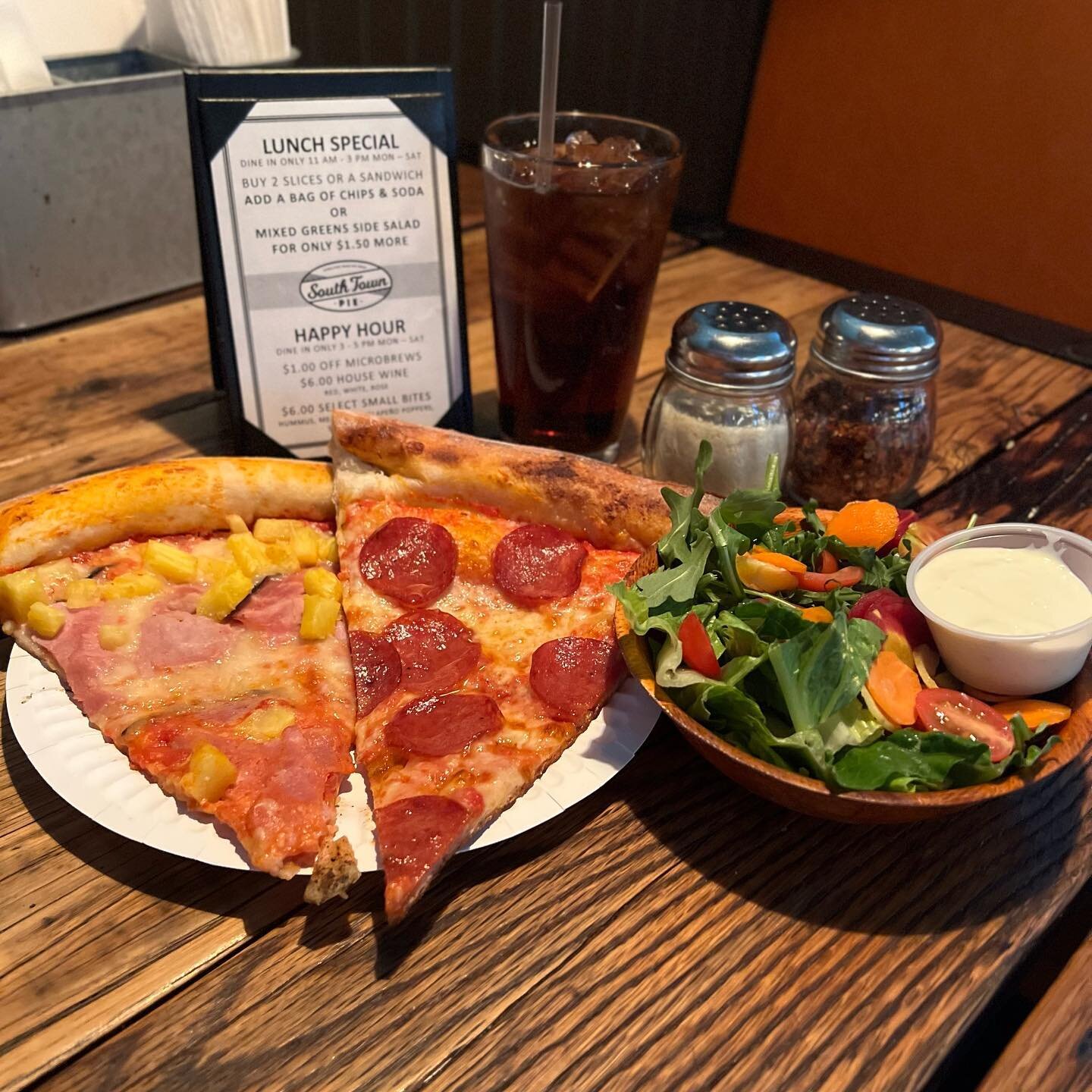 Don&rsquo;t forget about our lunch special! When you get two slices of pizza you can add a bag of chips + soda or a side salad for just a buck fifty!