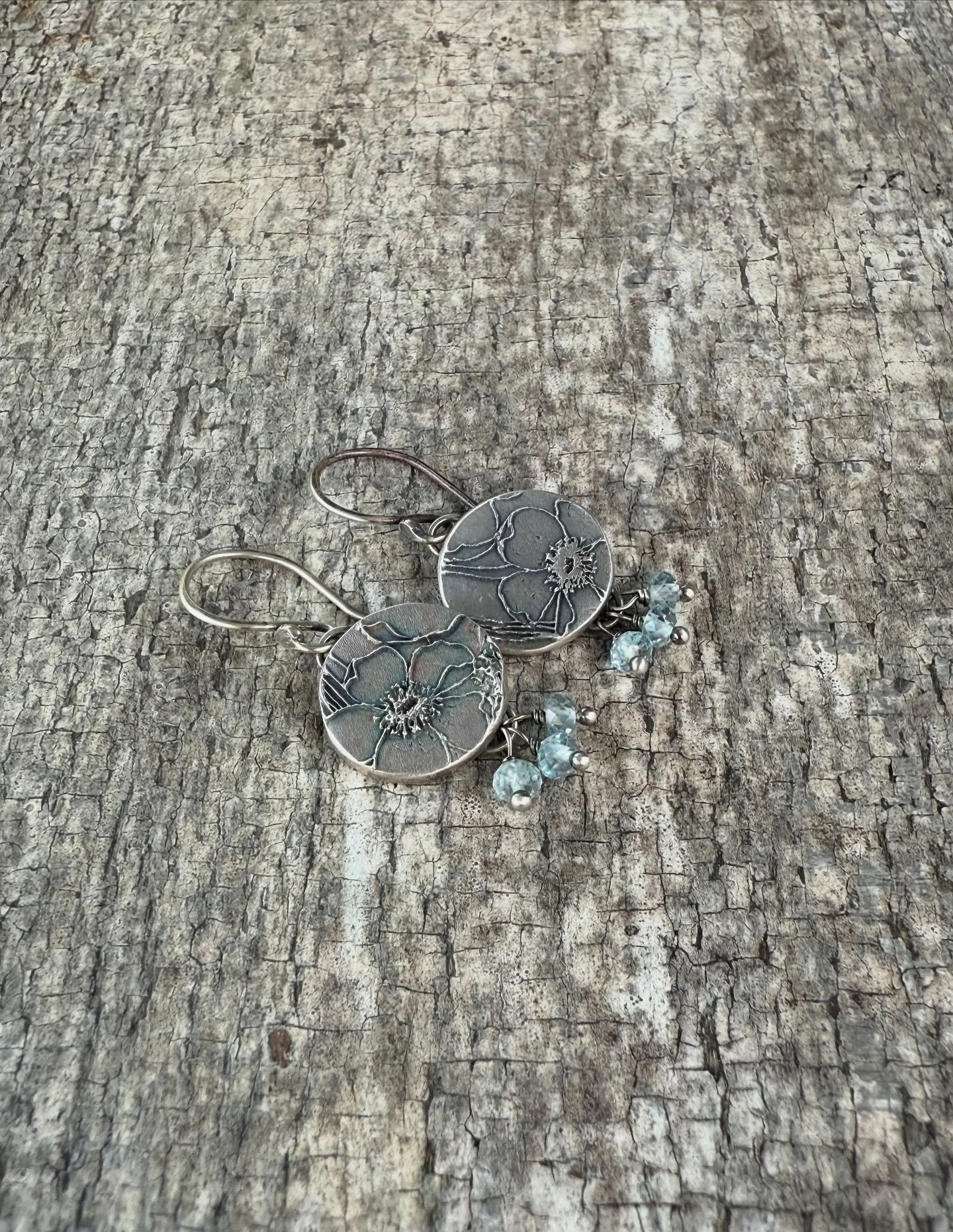 California poppies in bloom. 
Handcrafted in fine silver with a whisper of blue patina and faceted aquamarine gemstones. Made in sunny San Diego. #handmadejewelry #californiapoppies #summerjewelry #california #sandiego #aquamarine #nicholajewelry