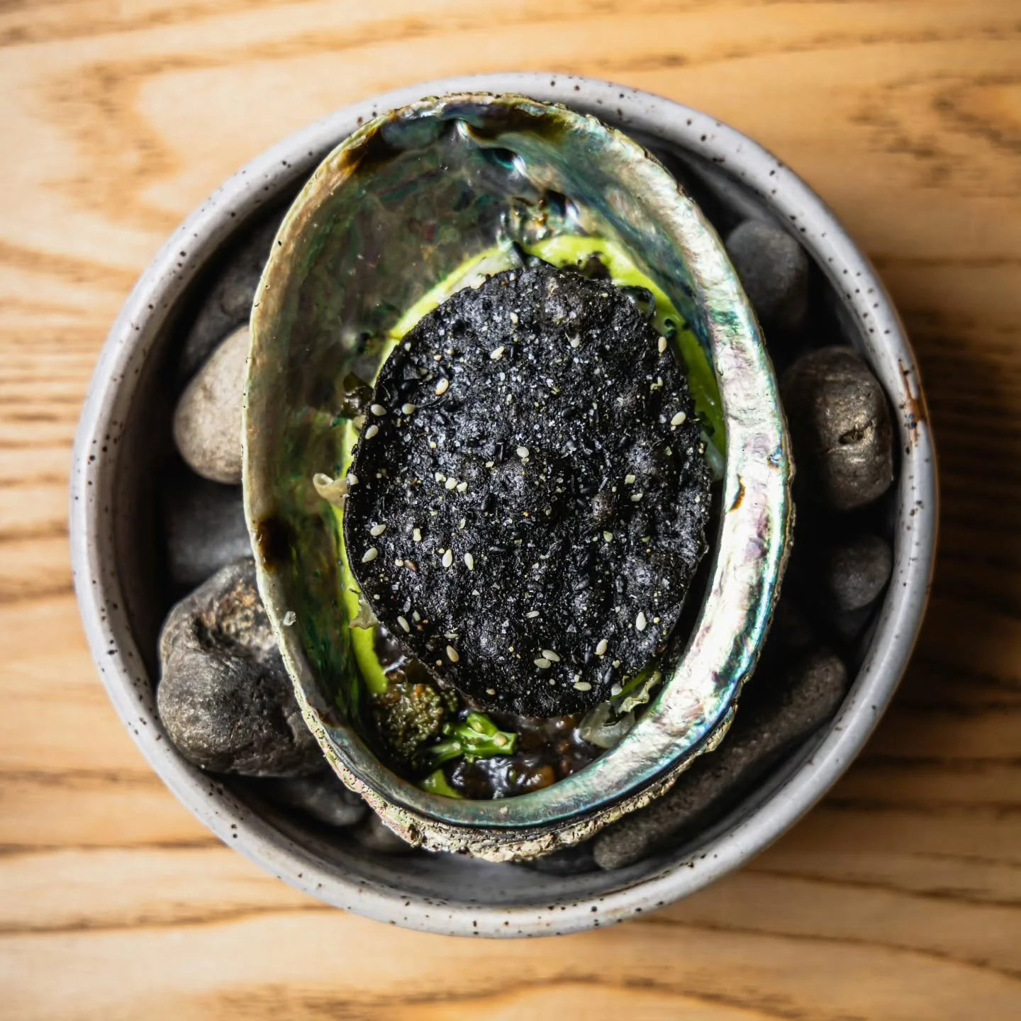 Paua - squid ink spelt risotto with sauteed paua, purple sprouting brocoli and seaweed. 
π @tora_collective 
π₯¦ @chefsgarden_nz 
πΈ  @thatgreenolive