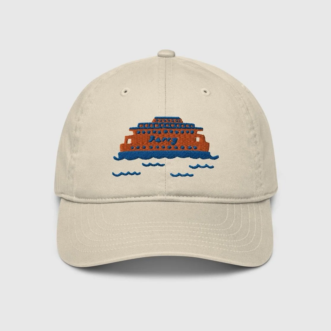 A beige dad hat with the Staten Island Ferry embroidered in the center with blue accents
