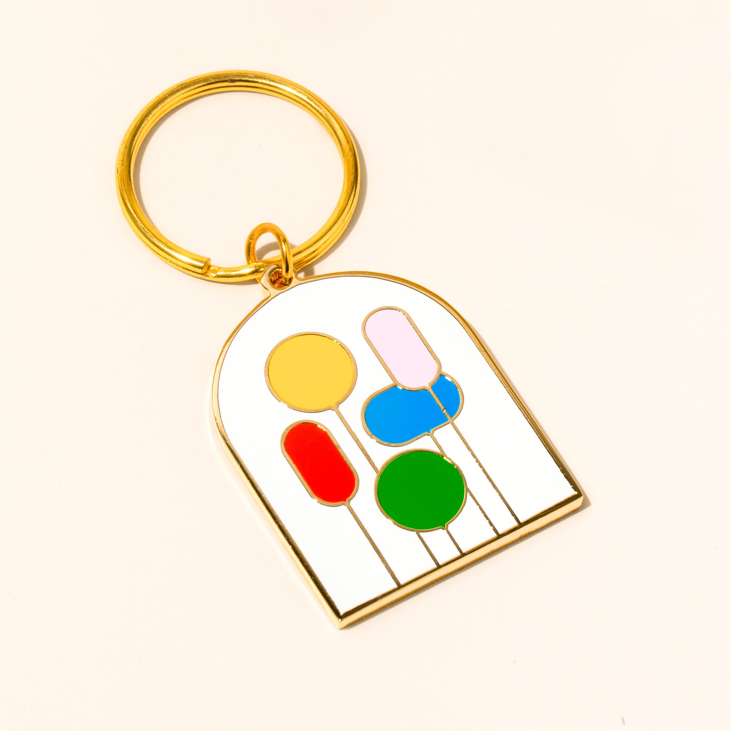 A vibrant, double-sided keychain showing a cluster of colorful abstract balloons floating upwards.
