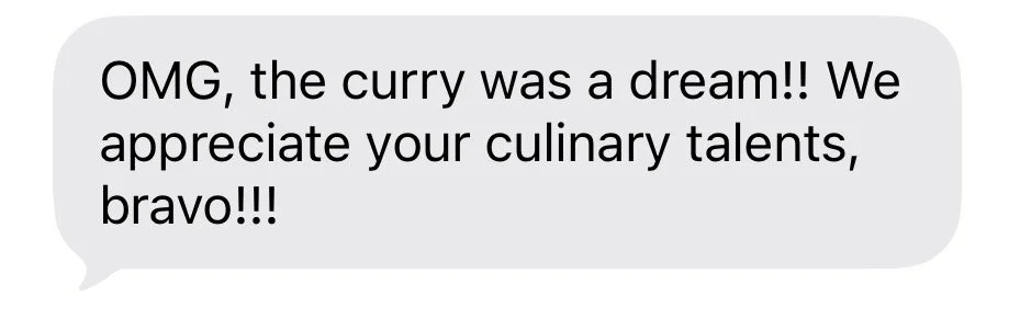 A text message praising someone's culinary skills and mentioning a dream about curry.