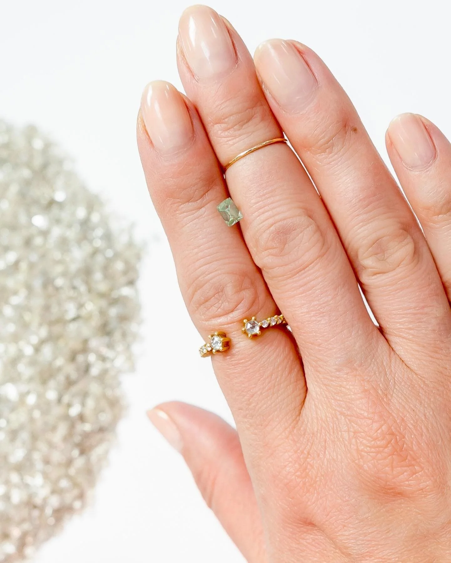 This mint colored small stone is a diamond, called Talisman for its unusual color. Talisman diamonds only come from one mine, Jwaneng, in Botswana. Sadly (for me) whoever buys it will probably polish it which will take off the color; it&rsquo;s only 