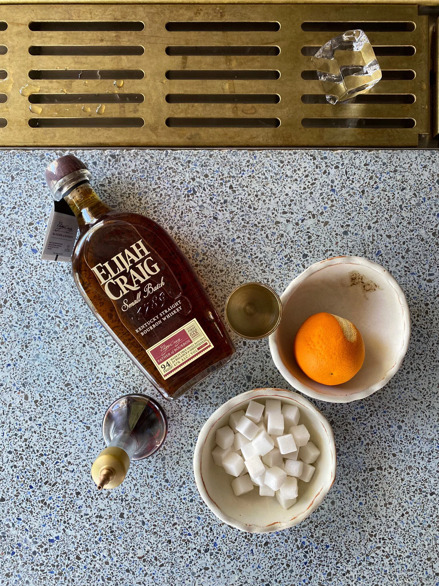 Piccalilli Old fashioned Cocktail ingredients: Elijah Craig Small Batch, Angostura Bitters, Cara Cara Orange, Sugar cube, maraschino cherry.