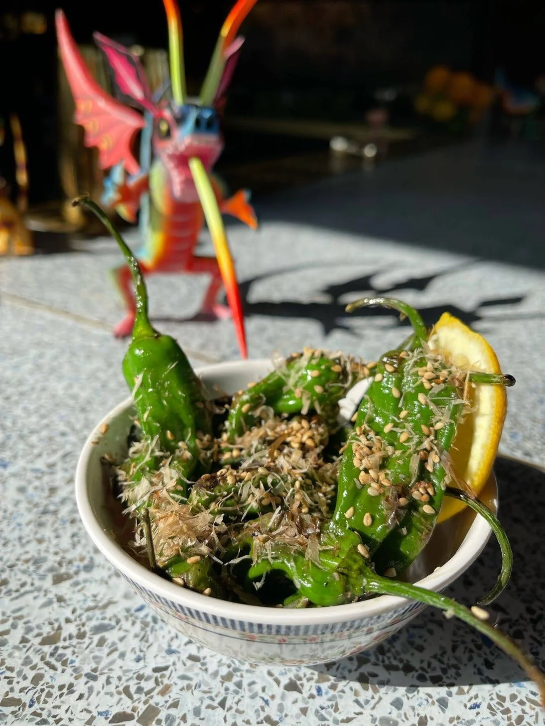 Wok’d Shishito Pepper with Maggie Sauce, Bonito Flake and Sesame Seed.