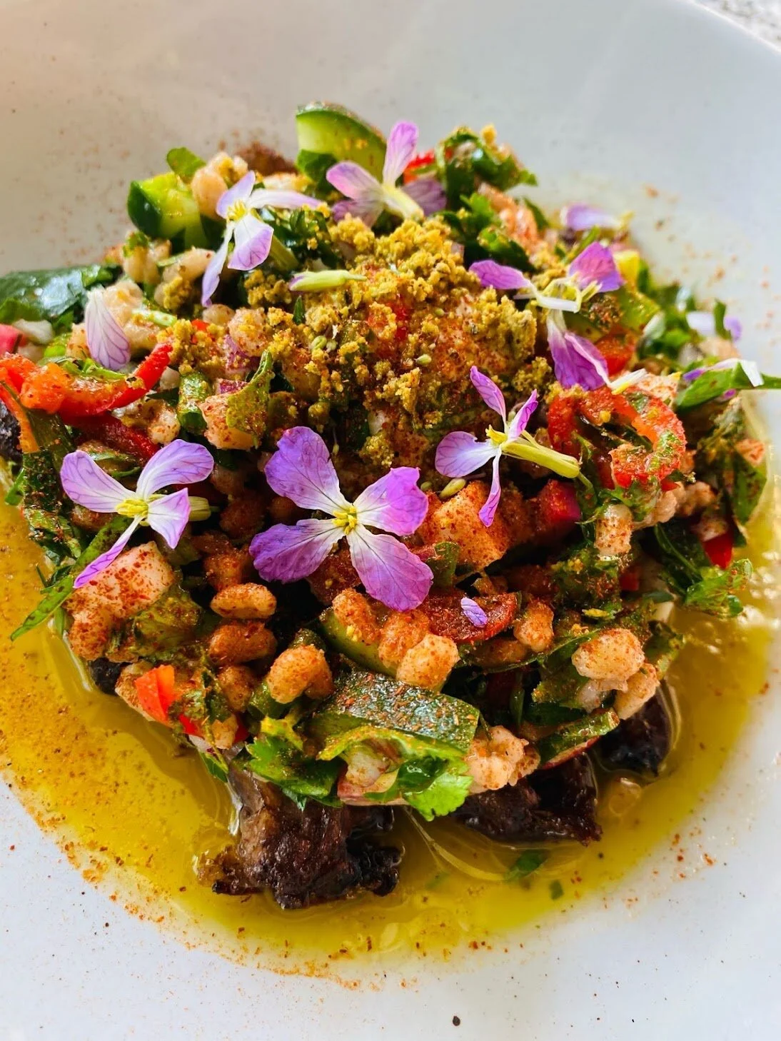 Roast Lamb Neck dish with baharat, labneh, smoked barley, herb salad, pistachio, lemon, and really good olive oil.