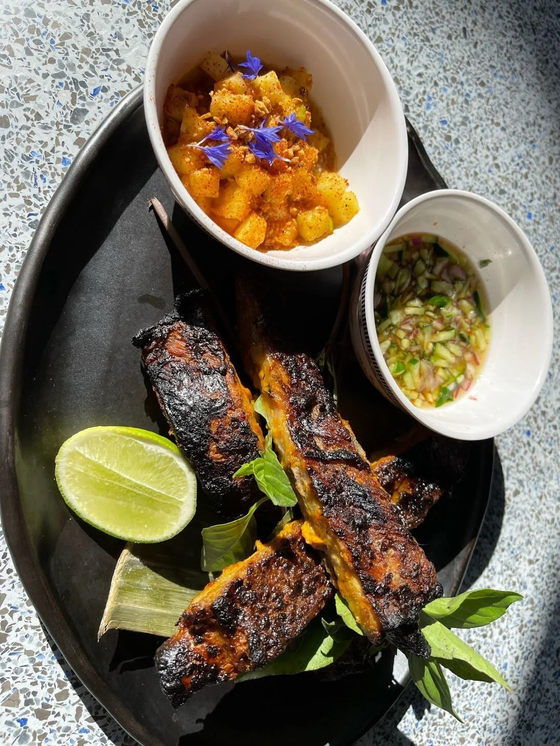 Coconut Red Curry pork Ribs with Pineapple achar, cucumber Nam Jim, Thai basil.