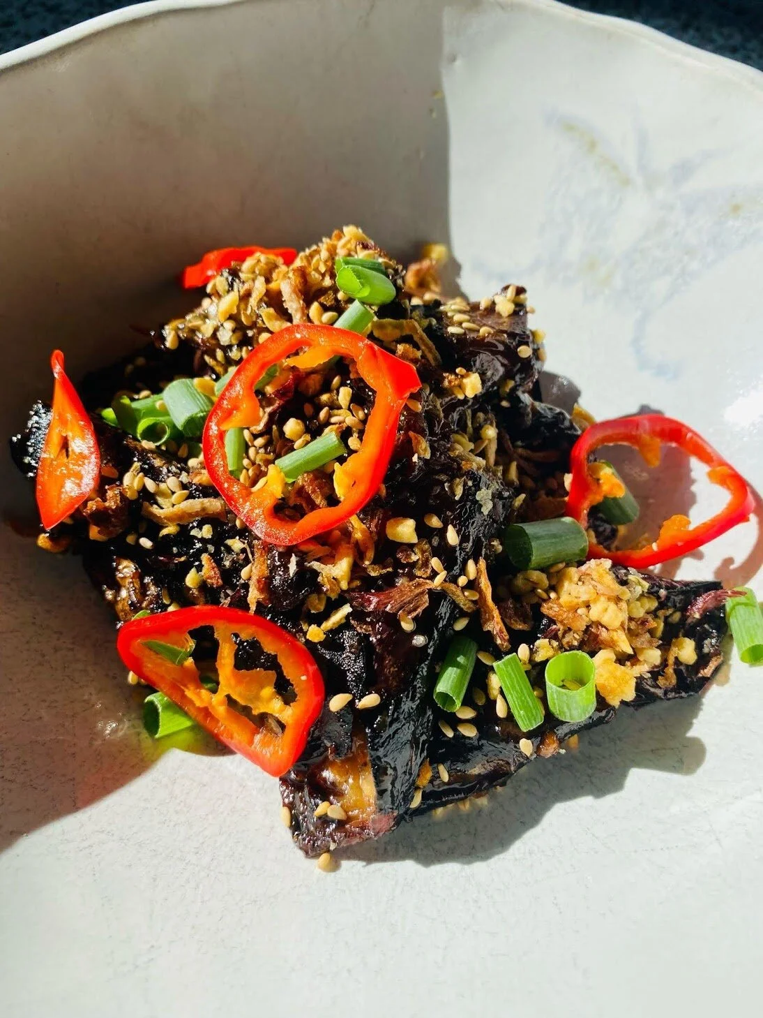 Wok’d Eggplant with Chinese Black Bean Sauce, Pickled Chilies, scallion and sesame seeds.