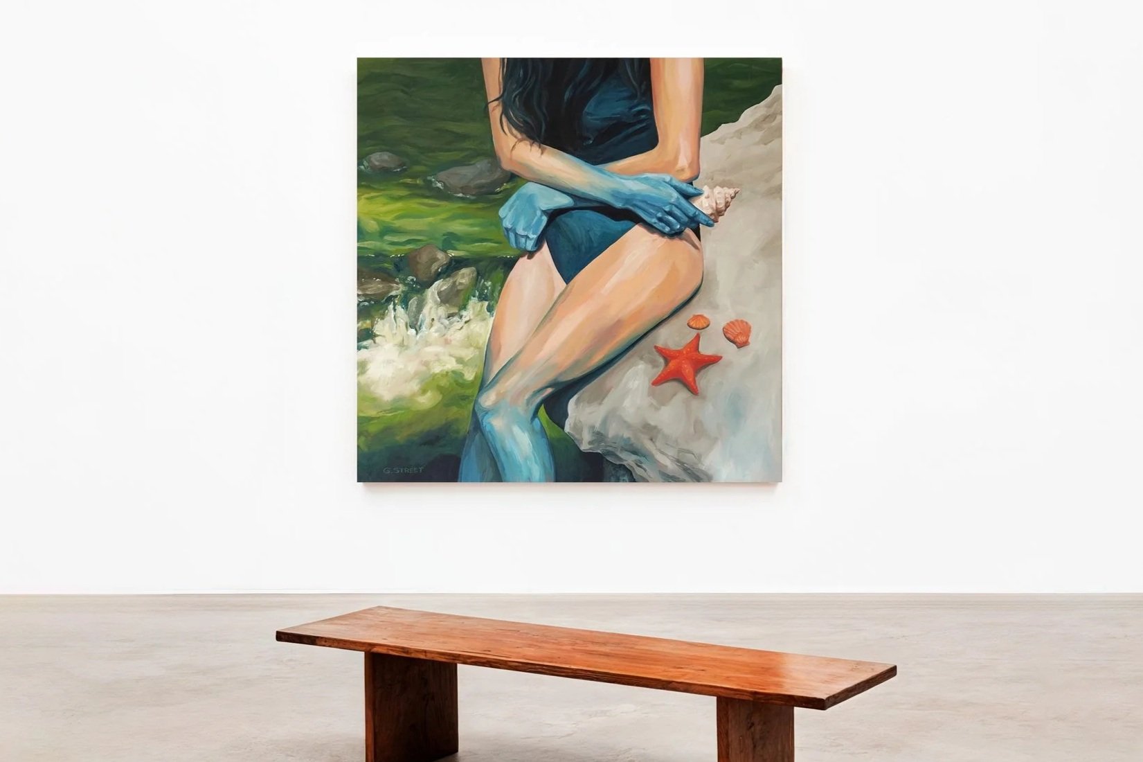 Painting of a woman sitting on rocks by the water, with starfish and shells nearby, viewed from the waist down.