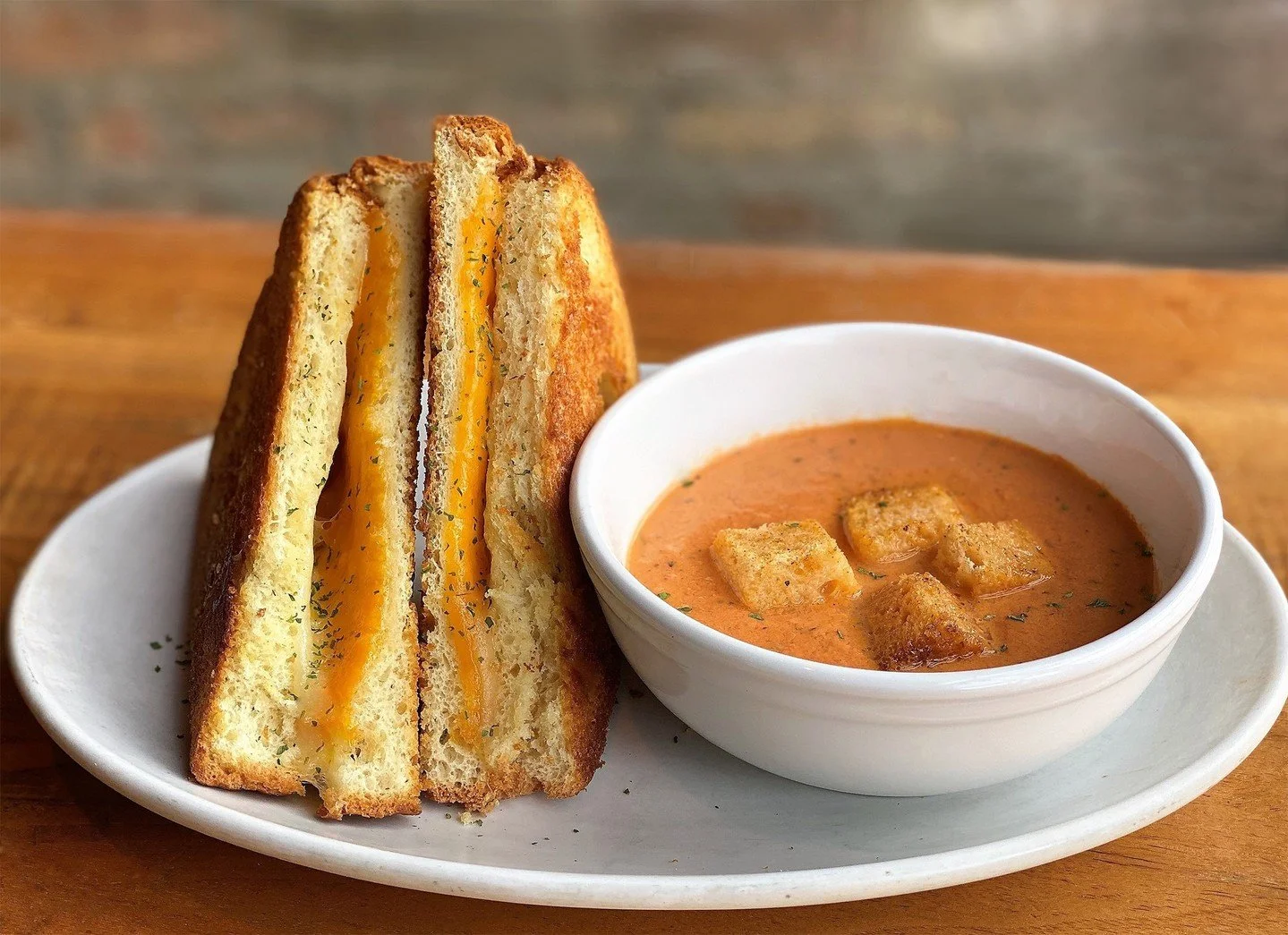 Chilly weather got you down? Our Grilled Cheese Sandwich with Cheddar and American on  thick-cut pan sourdough will cheer you up. Sure, you can get it with fries, but we like ours with our House Tomato Bisque for dunking! We'll be watching the Blue J