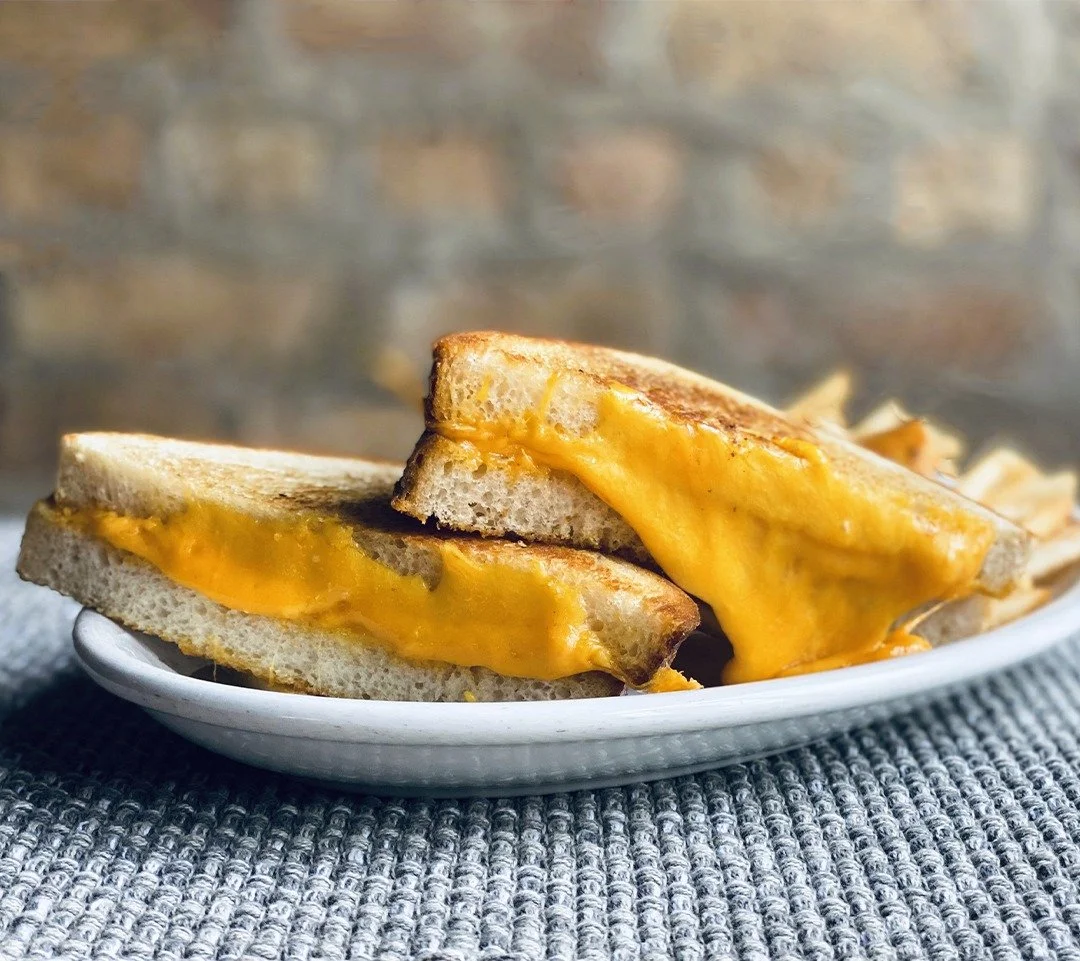 Our Grilled Cheese is loaded with Cheddar and American.  We nestle the cheese between thick-cut pan sourdough bread and it's griddled to perfection. We serve it with fries, but you can sub our house Tomato Bisque for no extra charge. April is Nationa