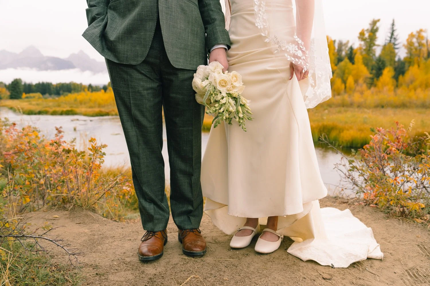 photo of a bride and groom's dress and shoes at schwabacher landing