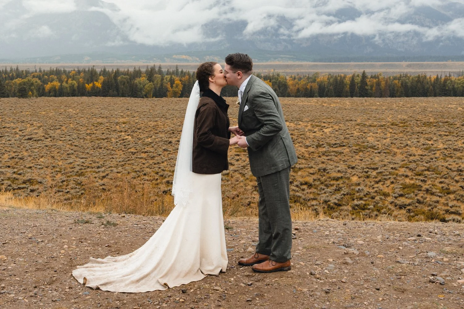 a bride and groom at their rainy glacier view turnout wedding