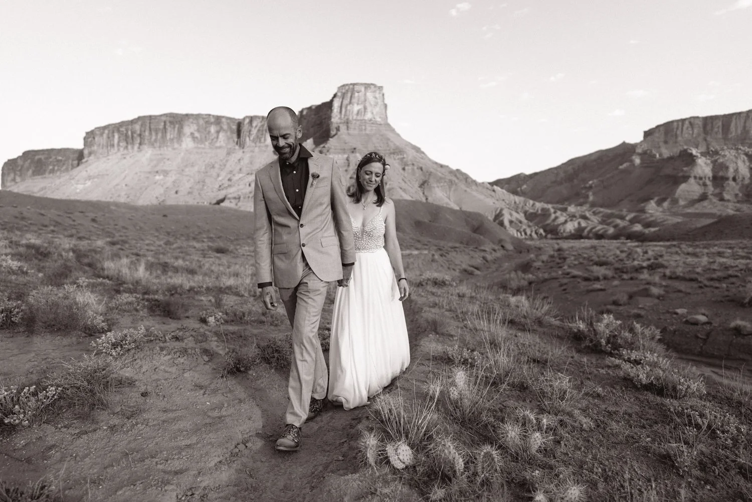 wedding couple walking in arches national park