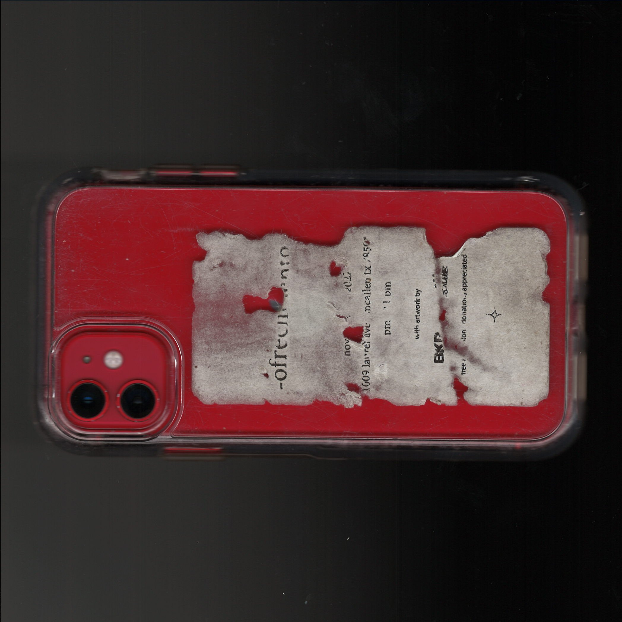 teaser 004 . i scanned my phone with a distressed flyer sticker on it