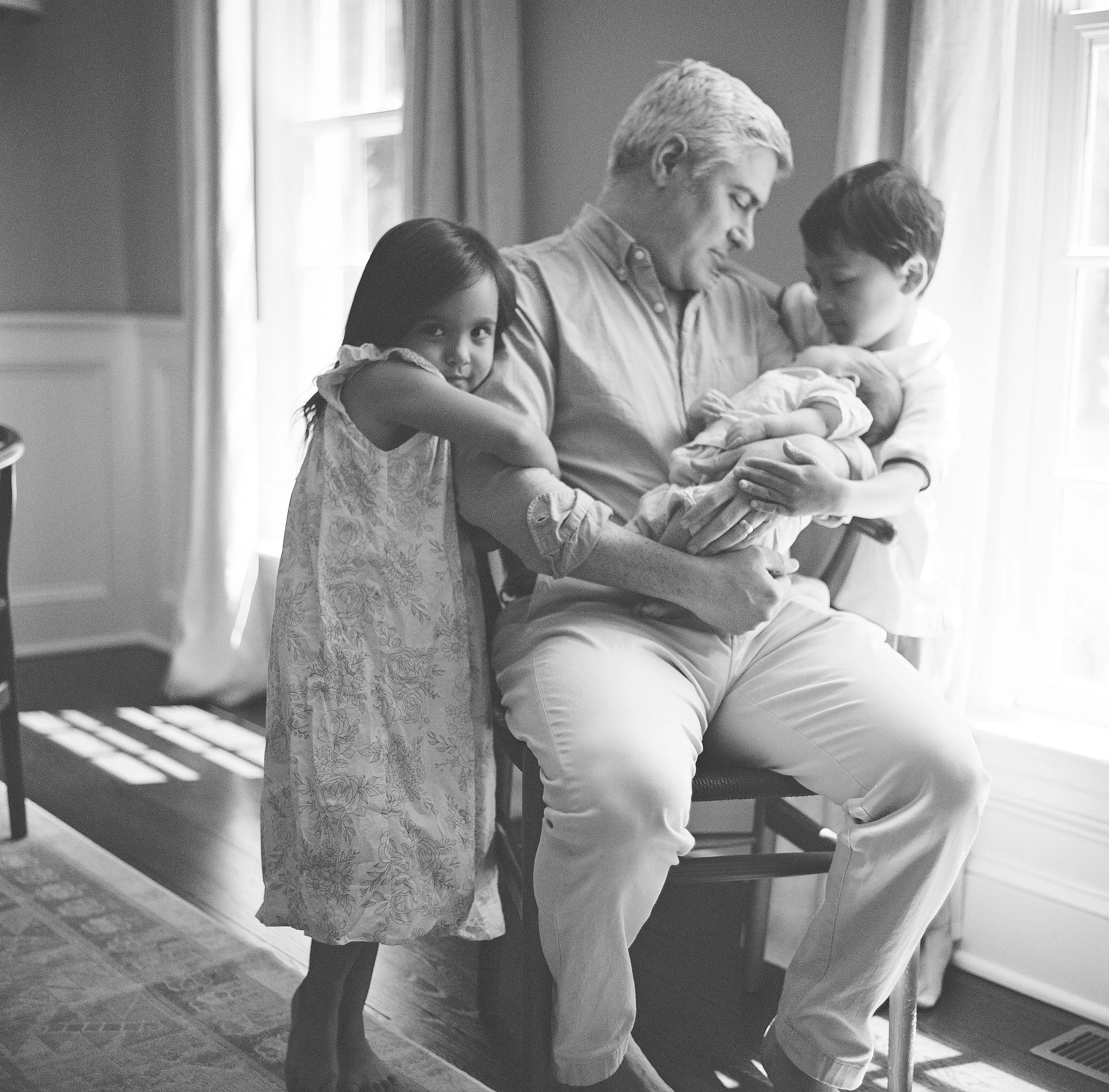 black and white image of dad with children