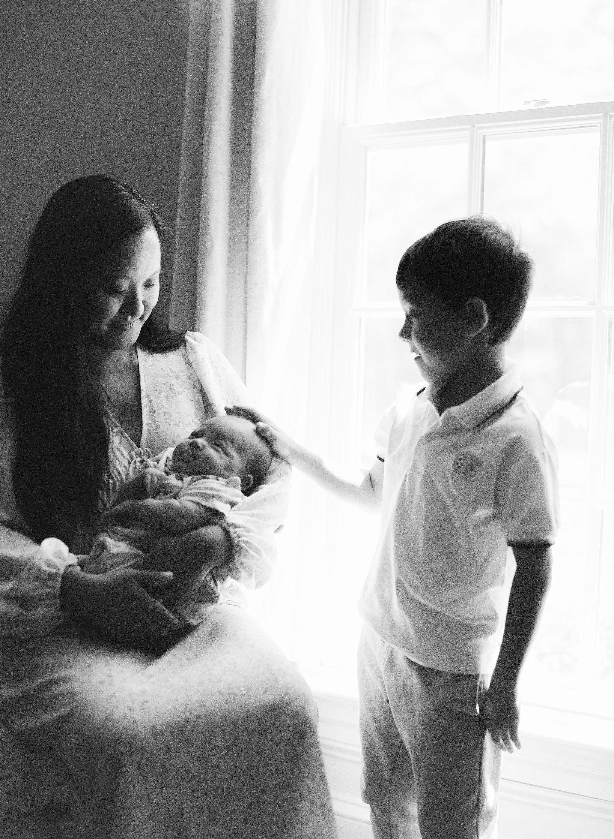 Black and White Film Image of Mother, infant and son