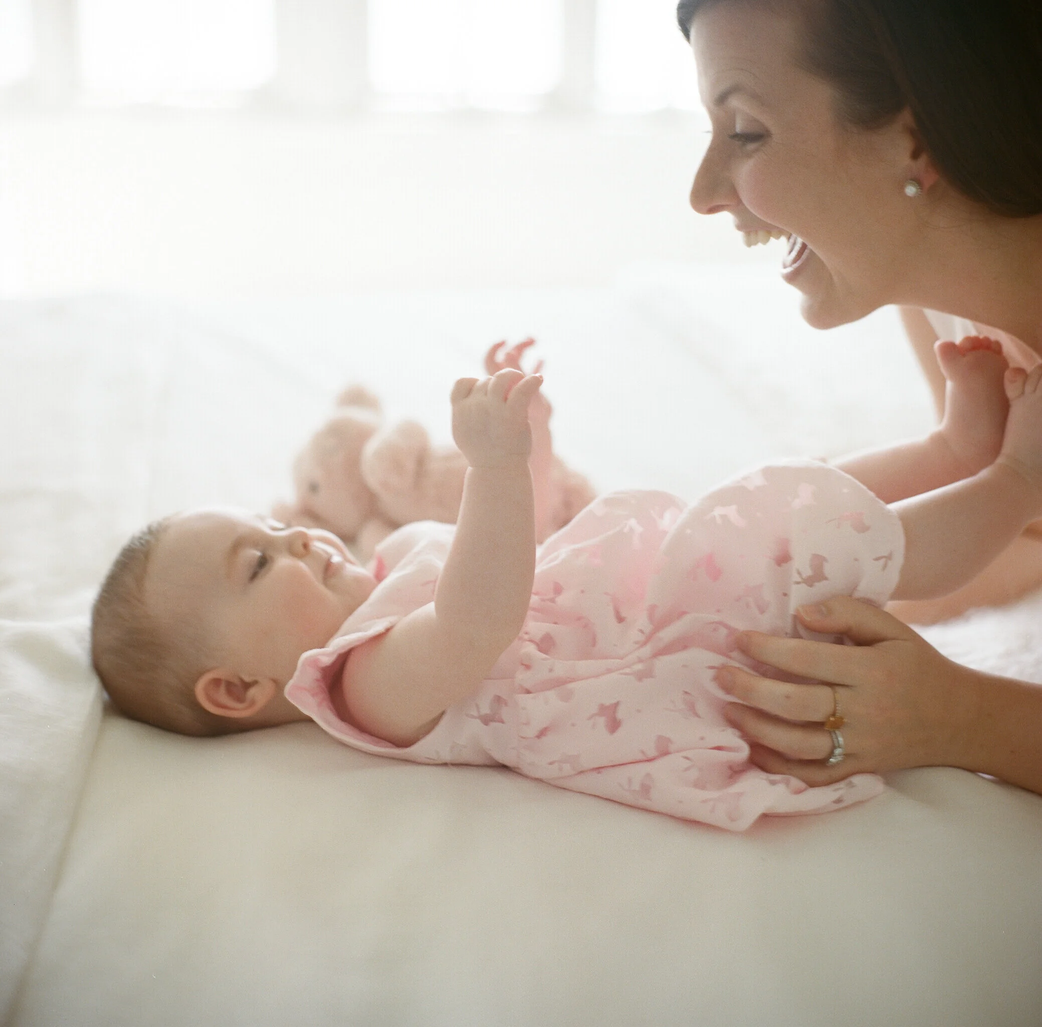 Film image of mom and baby smiling