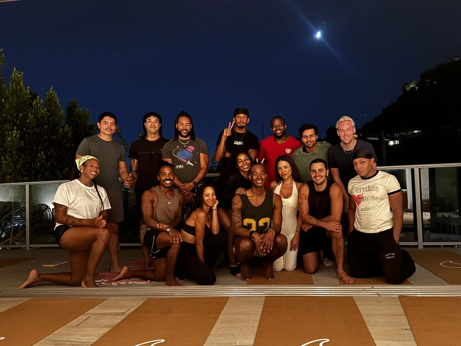 Group of participants after an INBETWEEN rooftop session at dusk