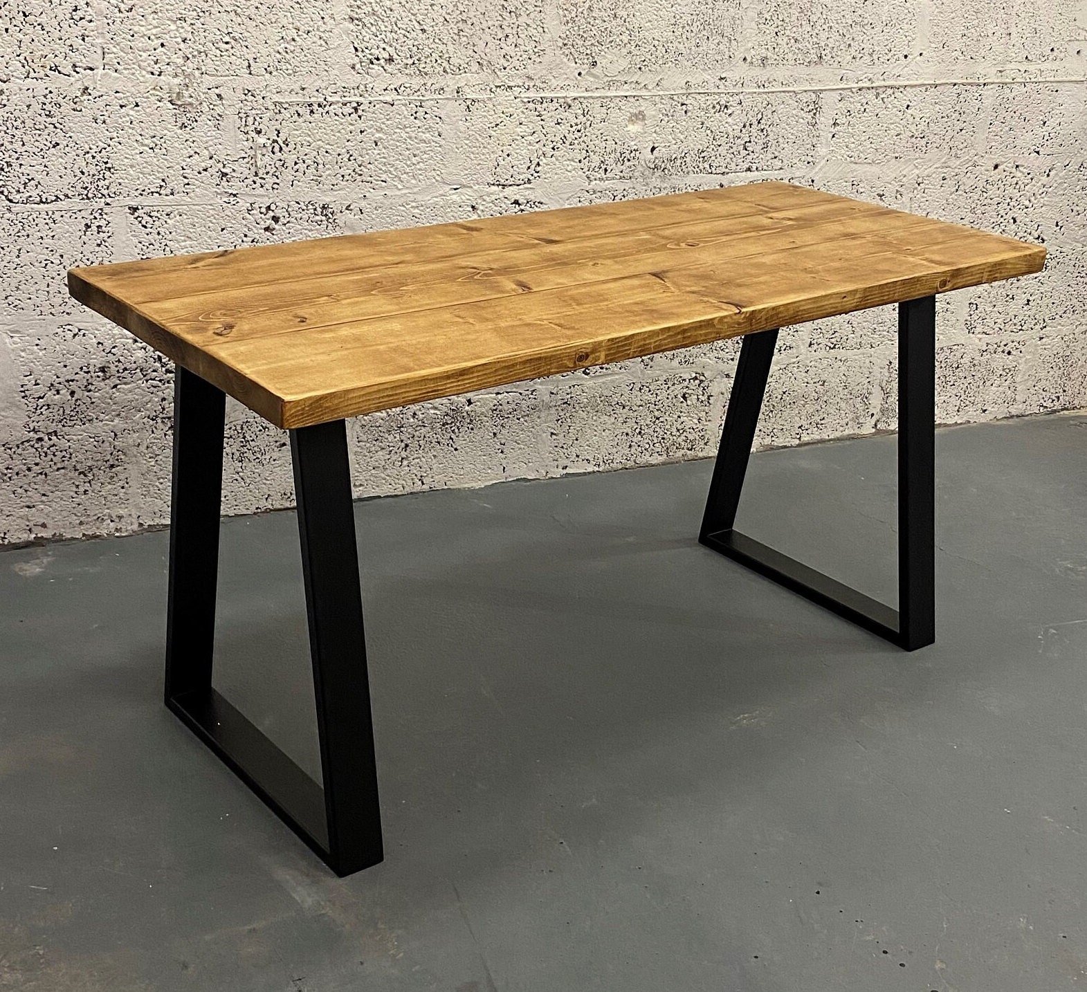 Rustic rectangular table with dark oak finish with black trapezium box section legs