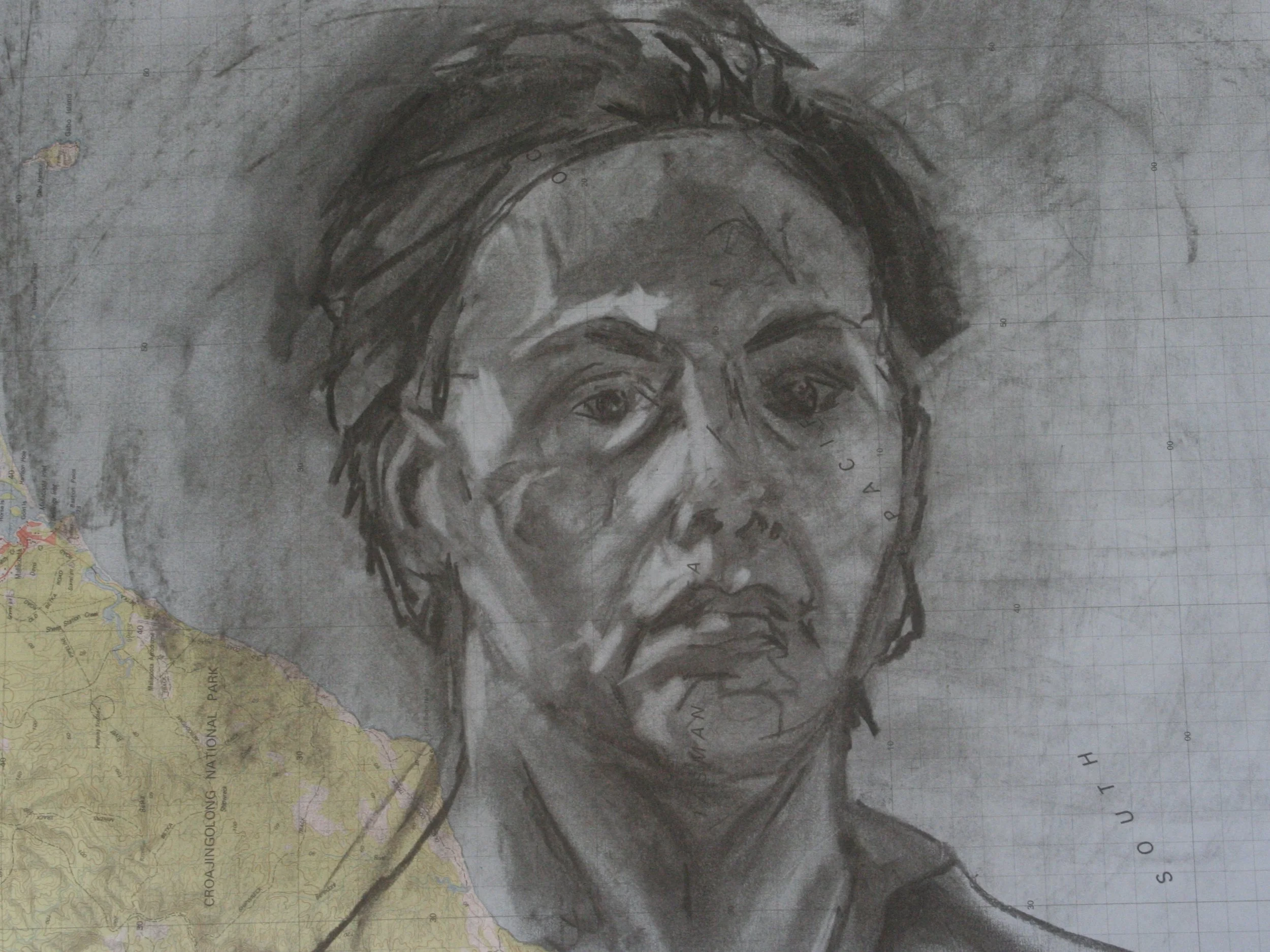 Self portrait on map (in charcoal)