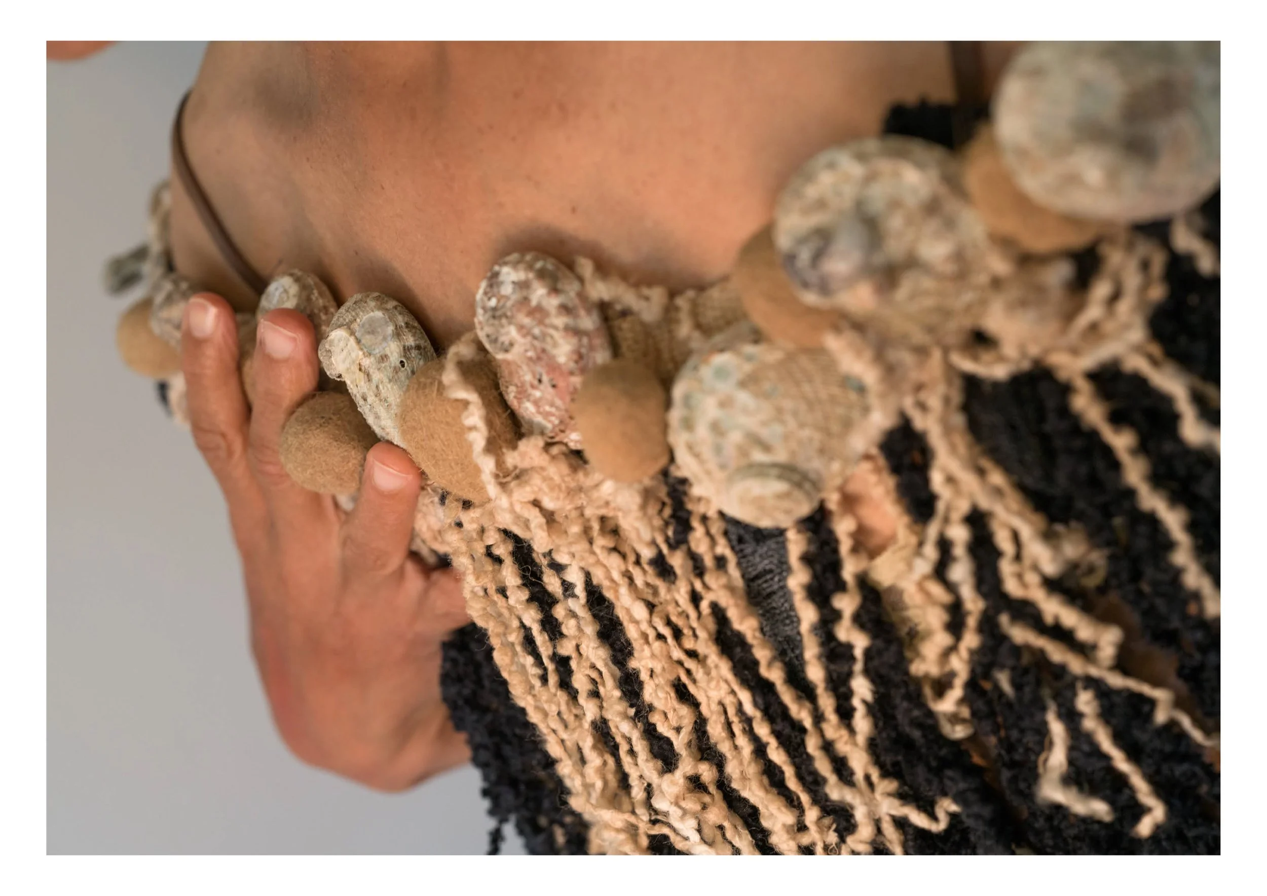 The gift of melancholy, 2025. Mixed media wearable (Abalone shells, tapeweed fibre balls, wool and cotton). Photo: Ana Koche. 