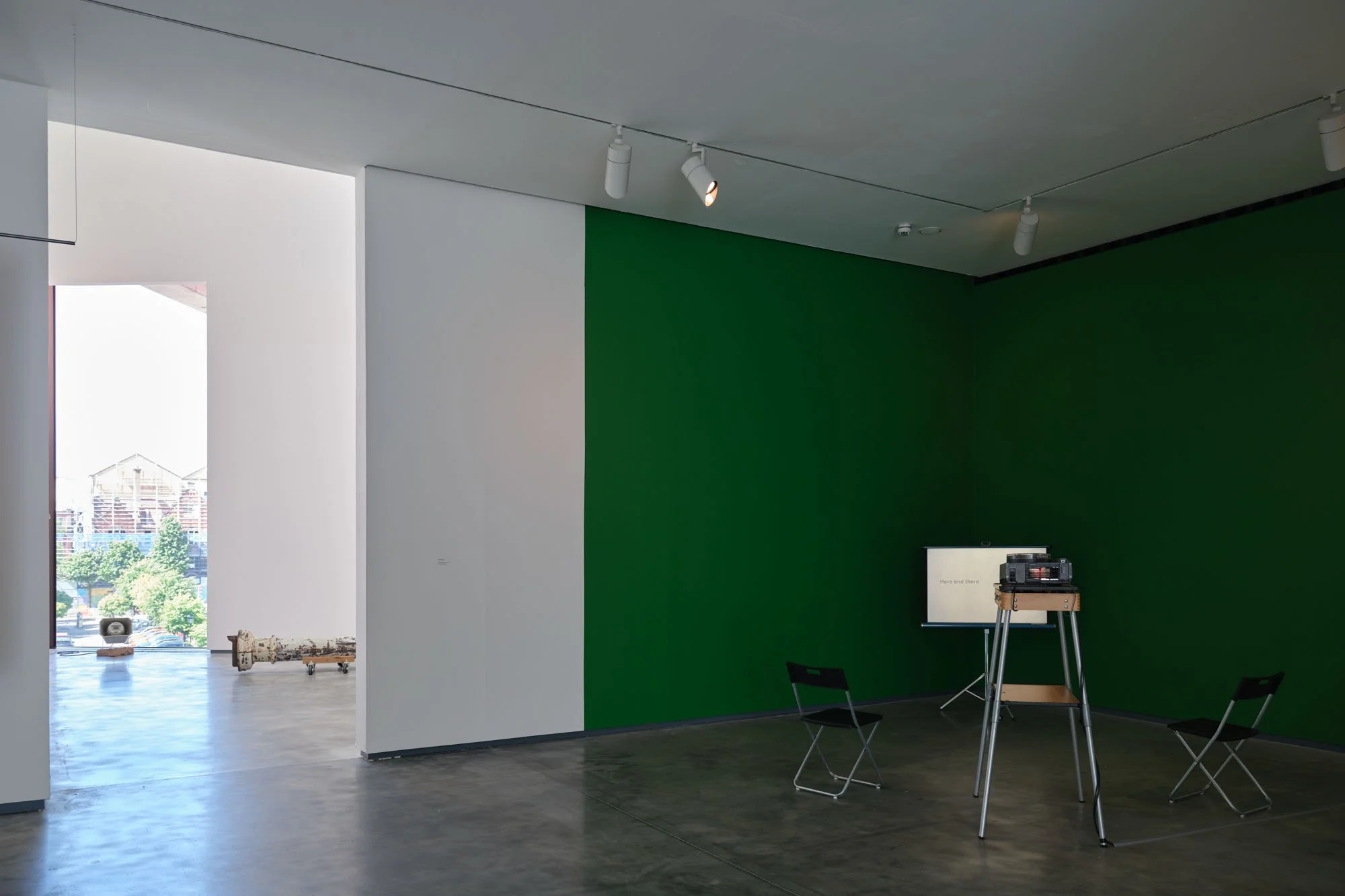 Christopher Steenson,  The Long Grass , 2022–24, 35mm slides, slide projector, vintage portable projection screen and projection table, timing system, amplifier, horn speaker, carved field stone, cabling. Dimensions variable. Duration: 5 minutes 49 s