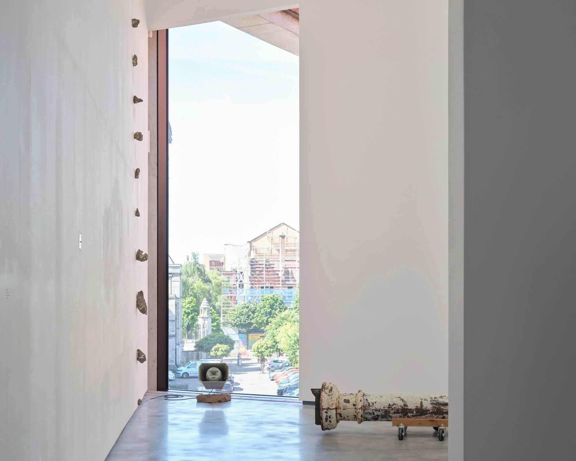 Christopher Steenson,  The Long Grass , 2022–24, 35mm slides, slide projector, vintage portable projection screen and projection table, timing system, amplifier, horn speaker, carved field stone, cabling. Dimensions variable. Duration: 5 minutes 49 s
