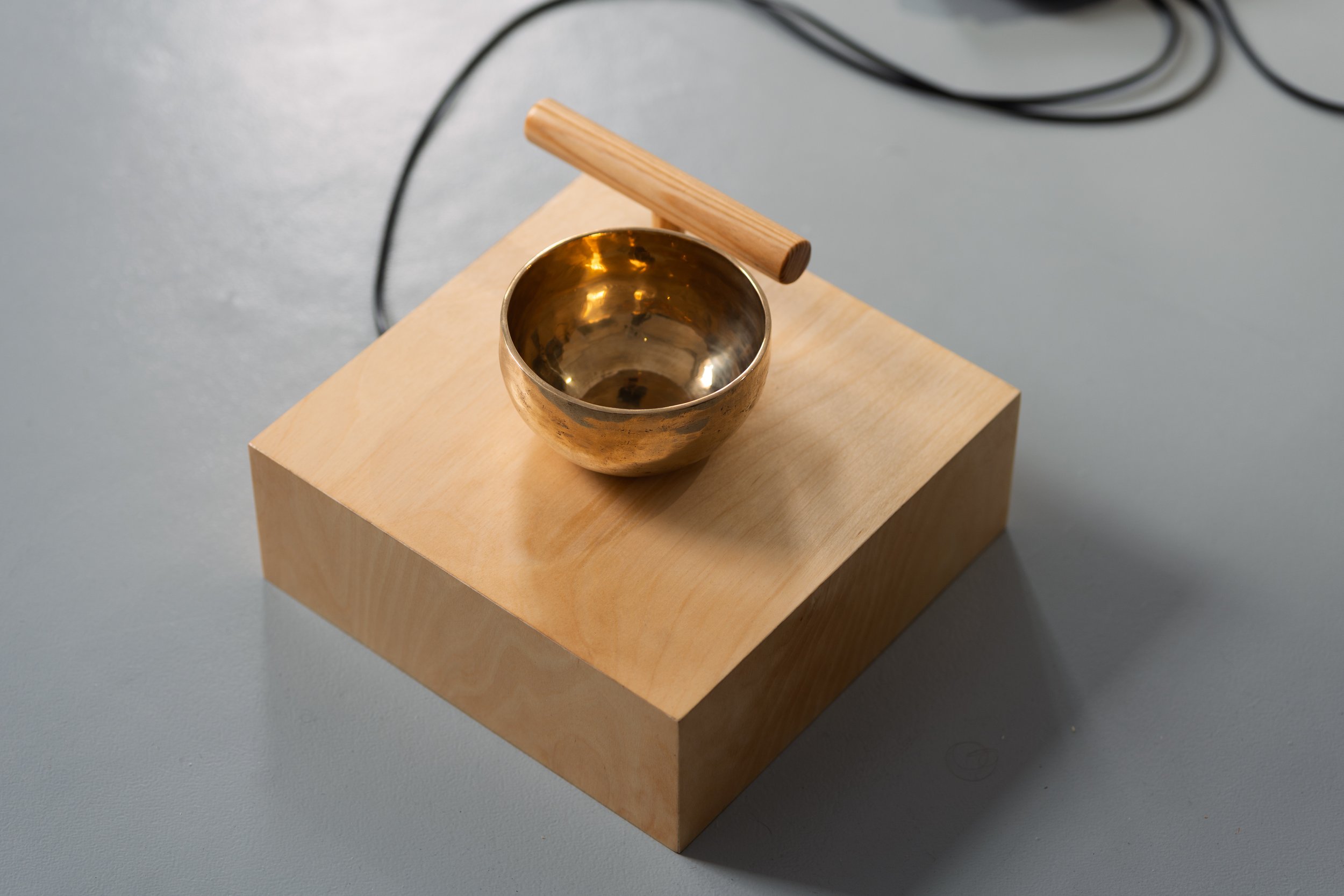  Where Does the Body End? , 2025, air quality sensor, singing bowls, chrome-plated pedestal fan, wood, carved stone, 3D-printed components, five-channel sound, custom software, Raspberry Pi microcomputers, Arduino microcontrollers, motors, circuitry,