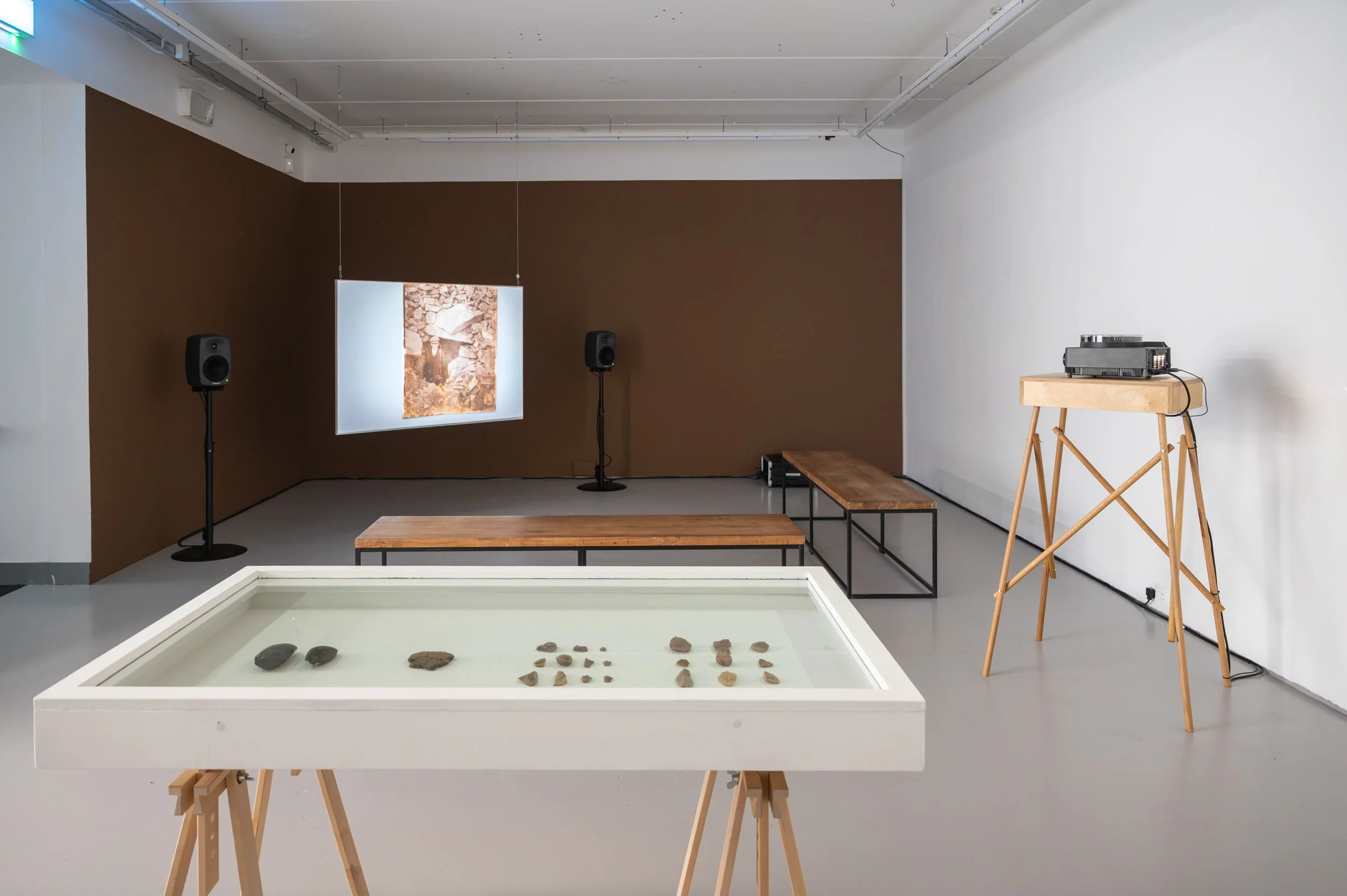 Christopher Steenson,  The Dragon’s Teeth , 2026, slide projector, 35mm slides, stereo sound, bespoke media timing system, cabling. Duration: 11 minutes (with 3 minute interval); with artefacts from Beaghmore Stone Circles and Alignments, Co. Tyrone.
