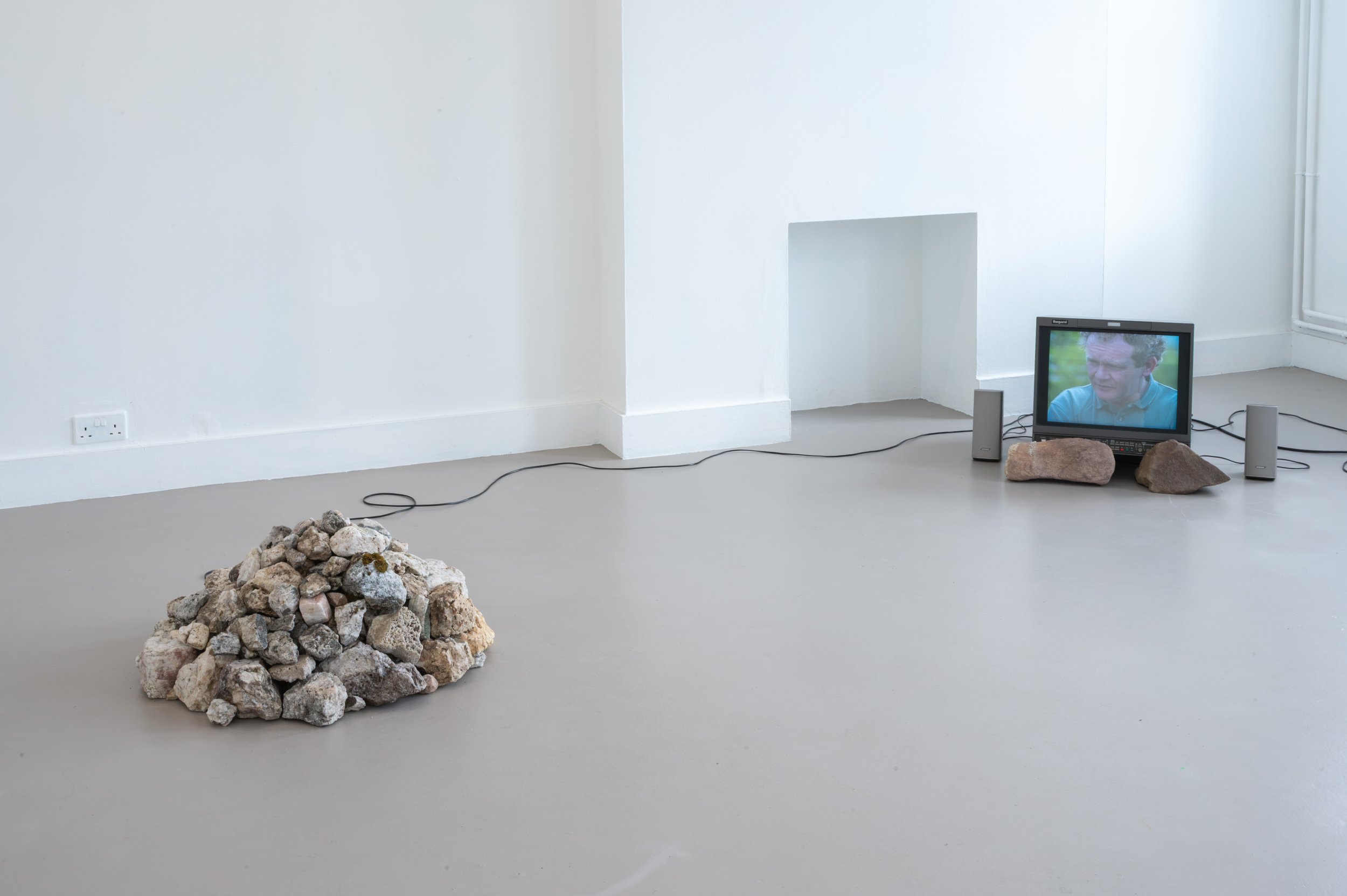 Vinny Cunningham,  Moving Border Bollards , 1994, HD, colour, stereo sound. Duration: 4 min 38 sec (looped), with 
Christopher Steenson,  The Movers , 2026, four-channel spatial sound, voices of collaborators, hand-collected rock quartz, speakers, st